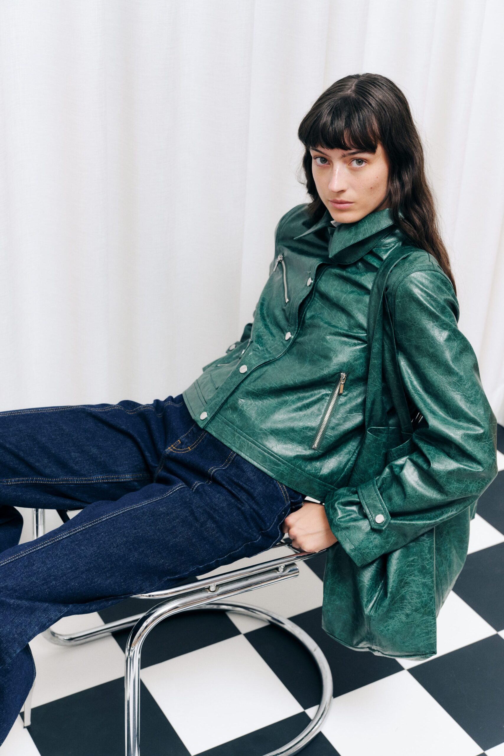 green leather jacket with blue jeans