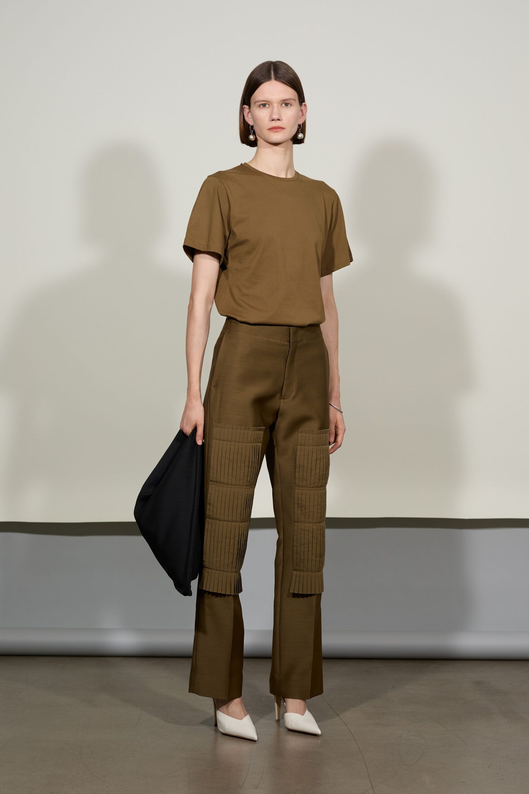 brown t-shirt green pants white shoes