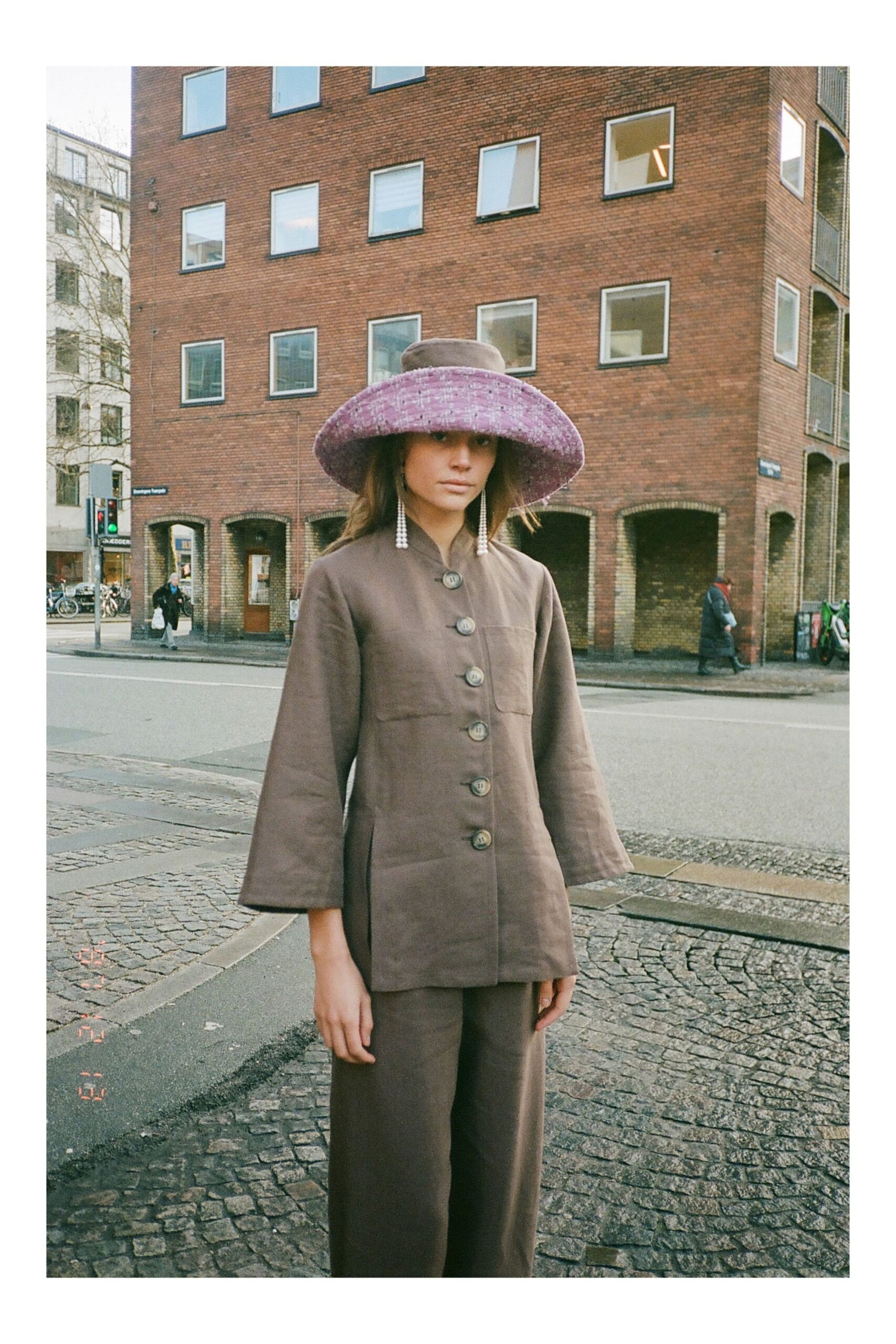 brown relaxed jacket and pants with purple hat