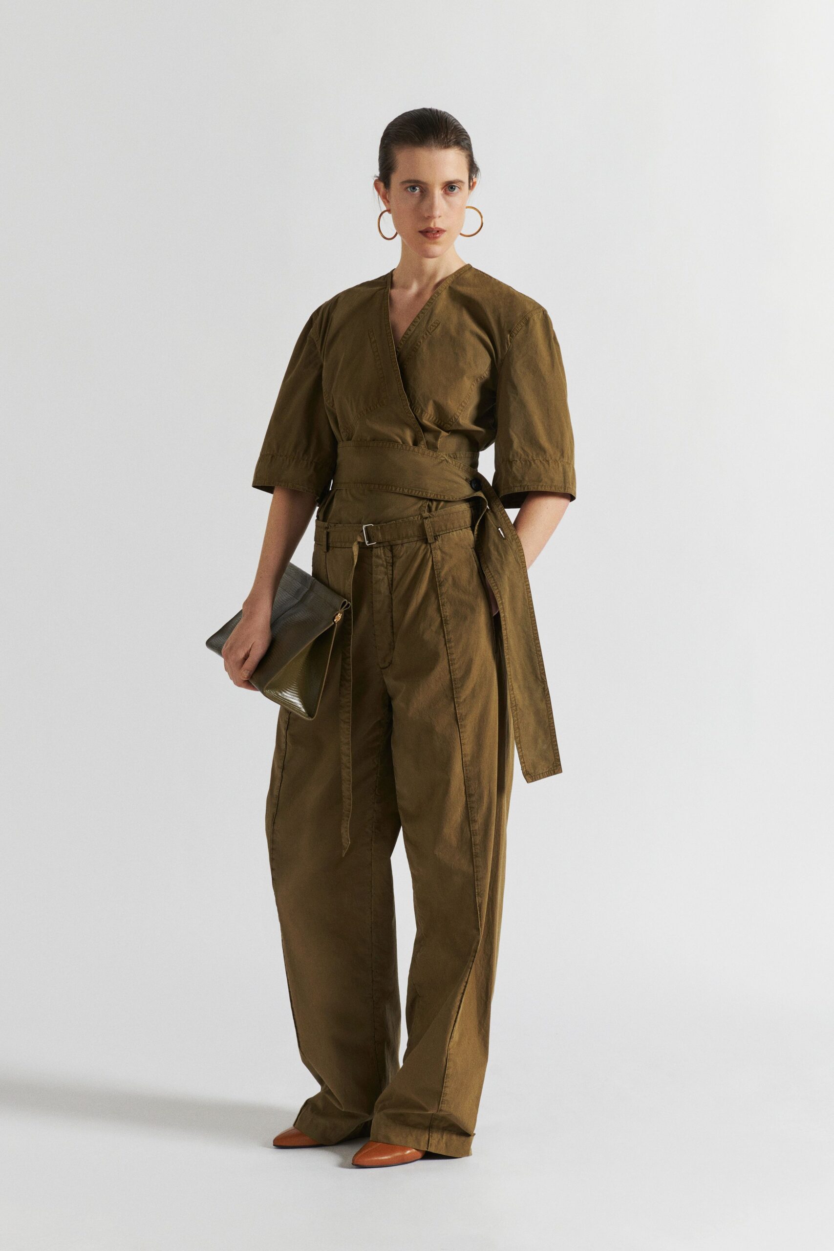 brown relaxed jumpsuit with green bag