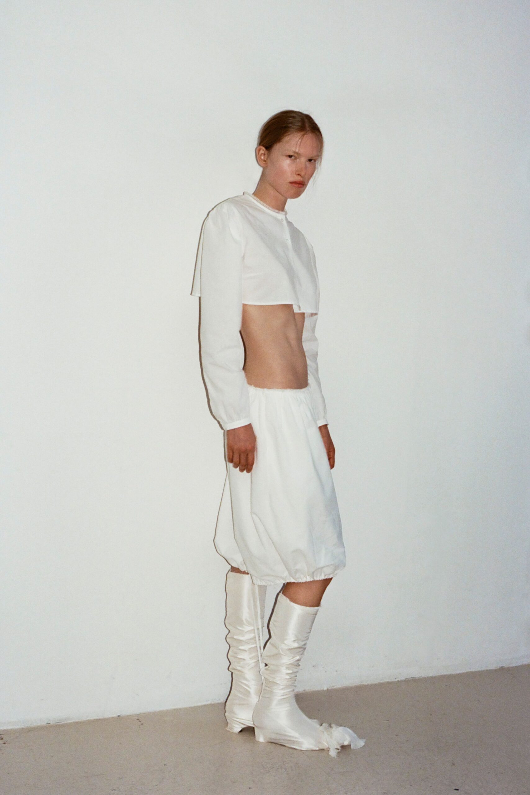 white cropped top and skirt with boots