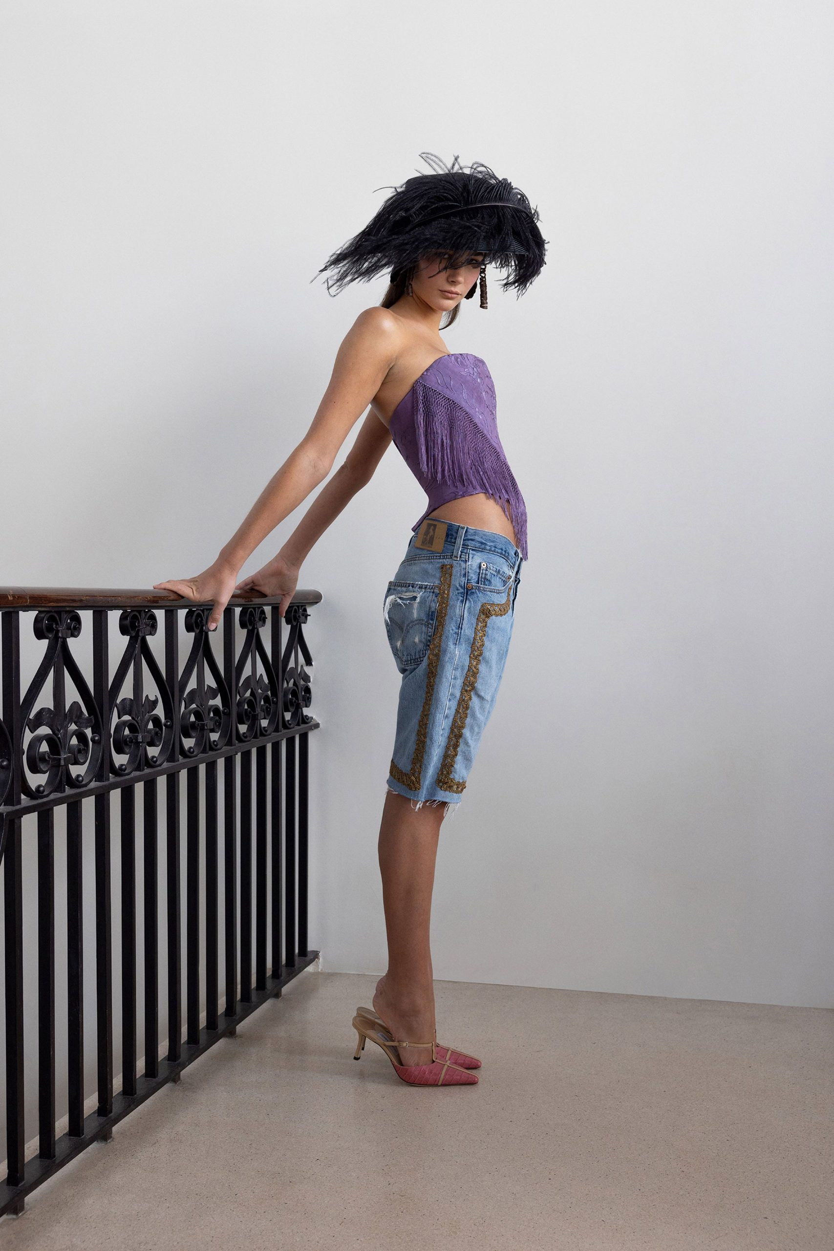 purple fitted top with denim shorts