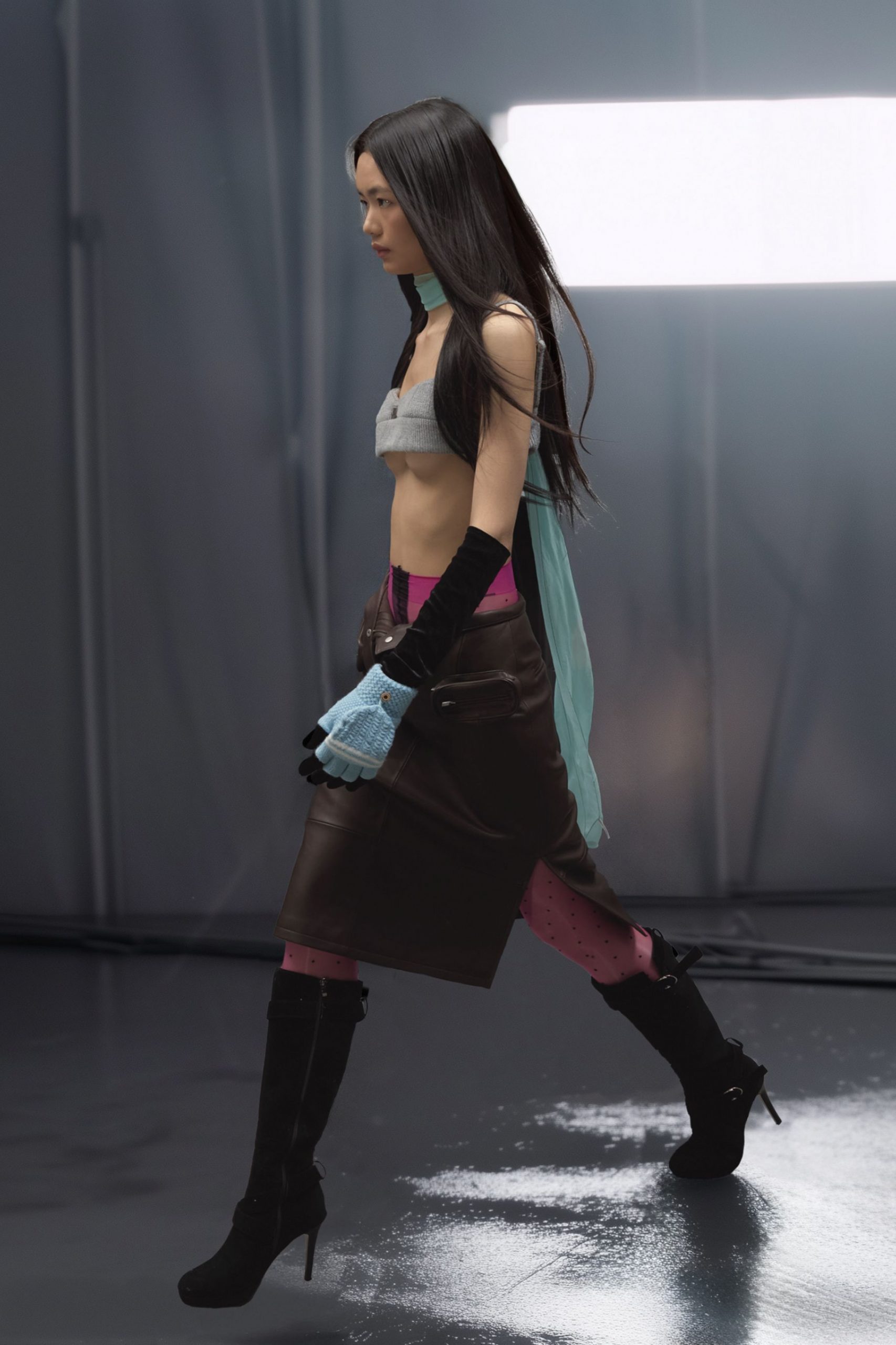 gray sleeveless top with leather skirt