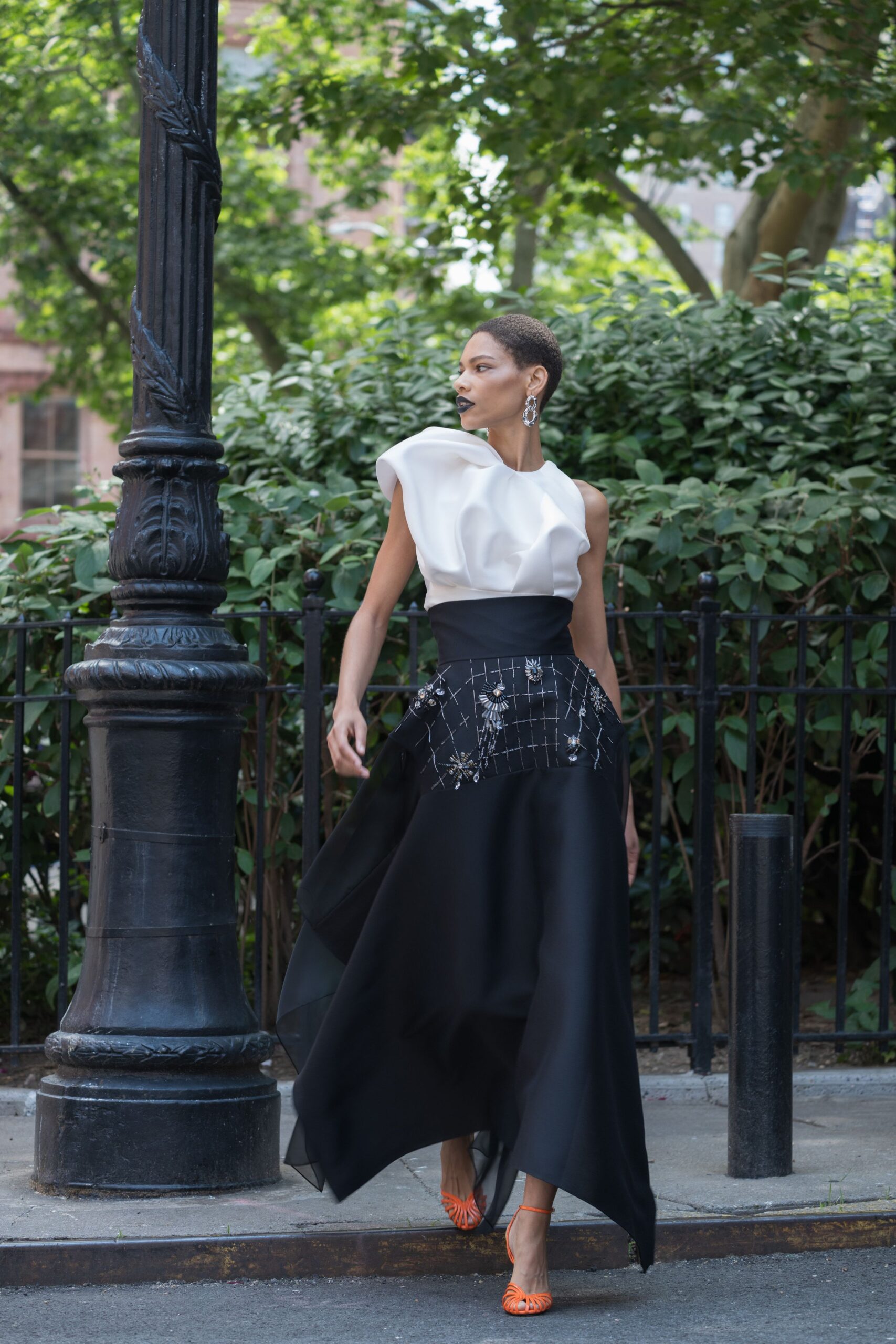black and white flowing gown with orange shoes