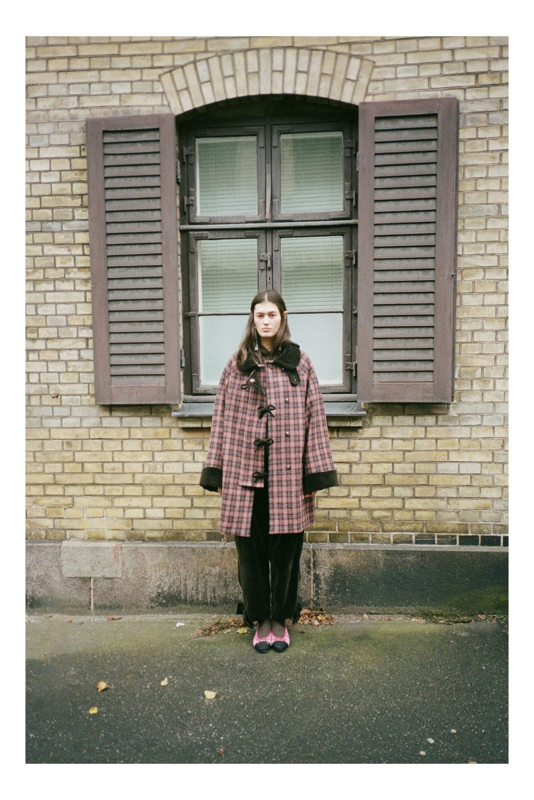 pink checked coat with black pants