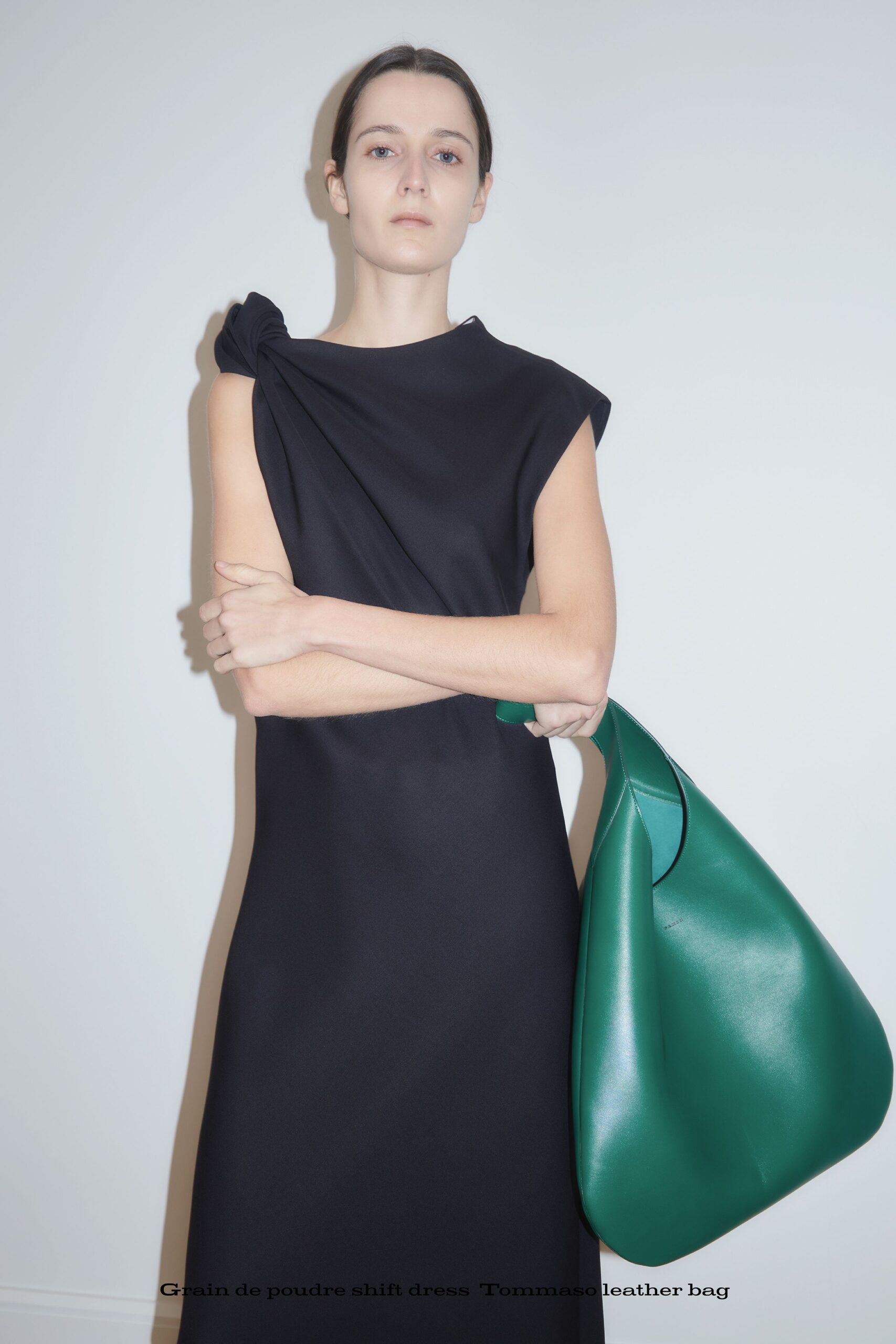 black fitted shift dress with green leather bag