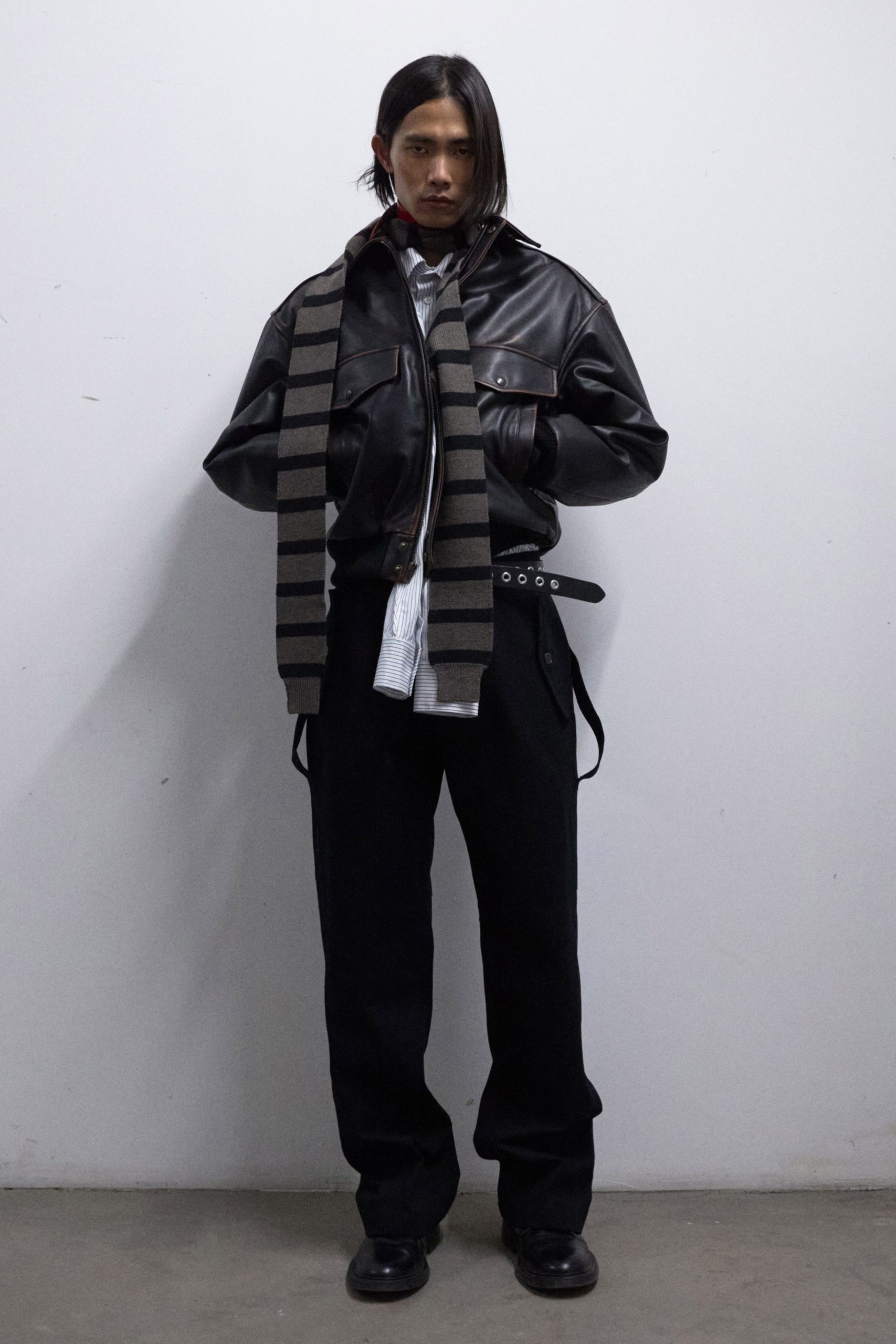 black leather jacket with striped scarf