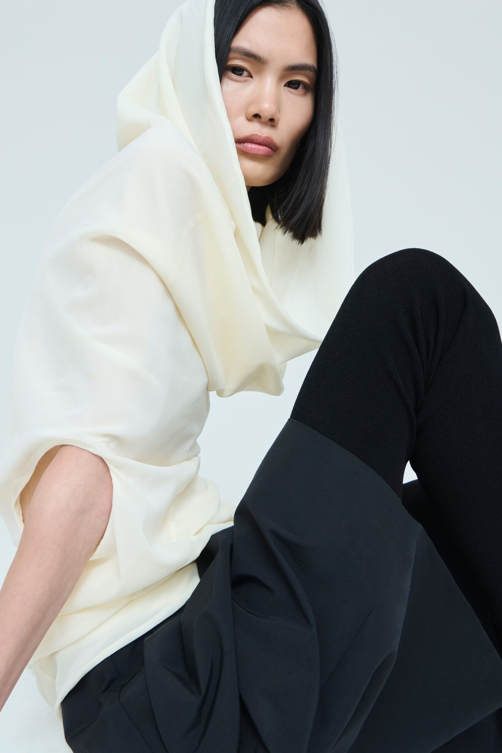 white relaxed top with black skirt