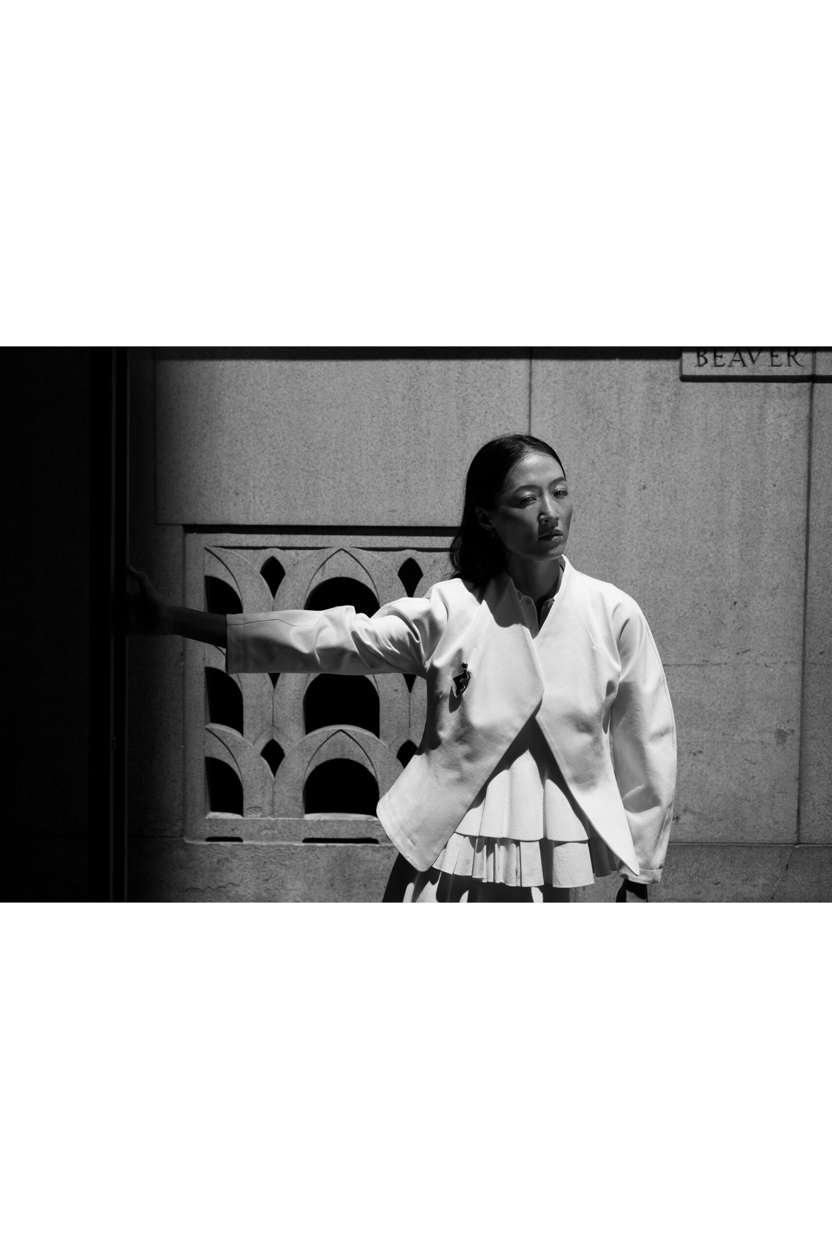 white fitted jacket over pleated dress