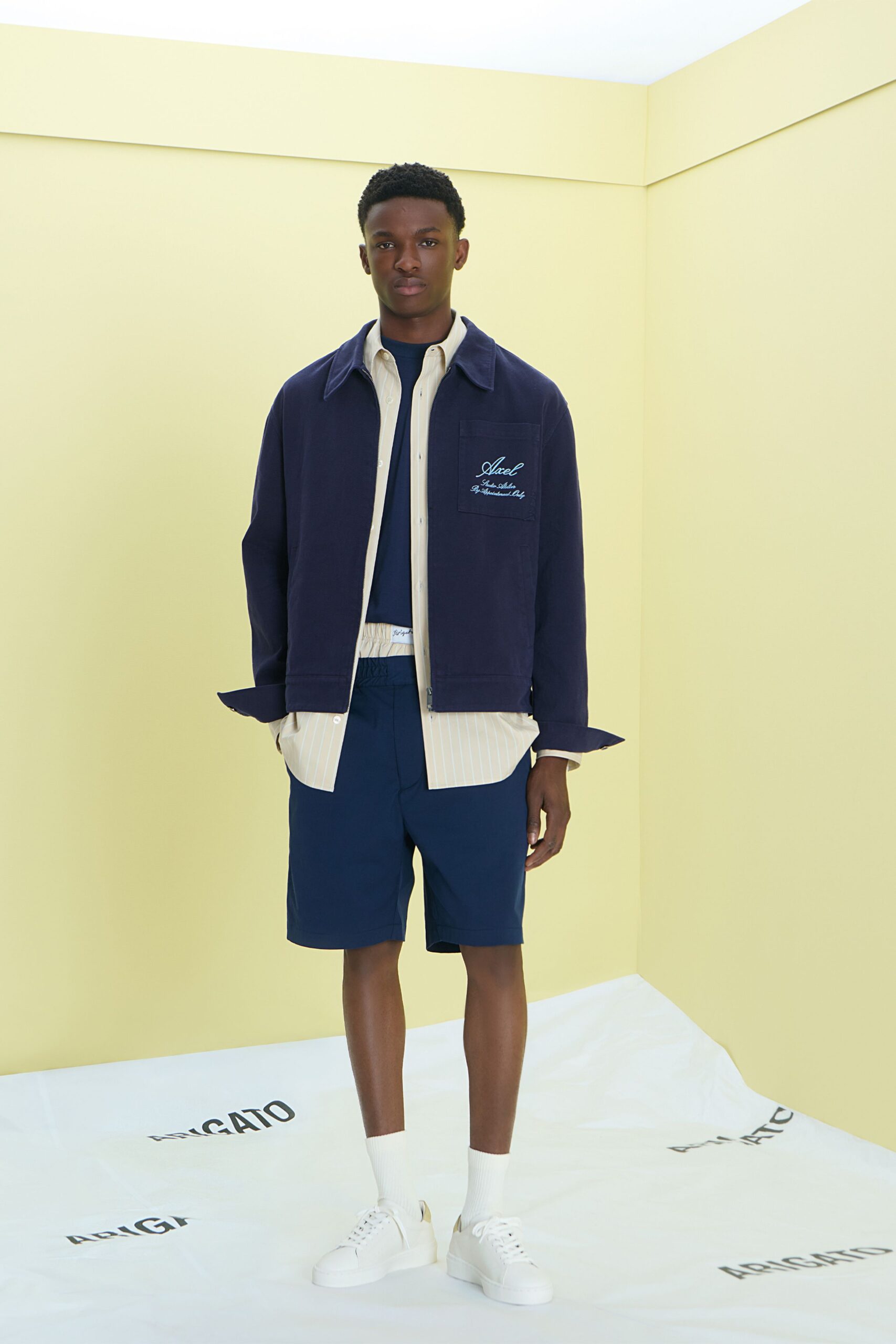 navy jacket beige shirt navy shorts
