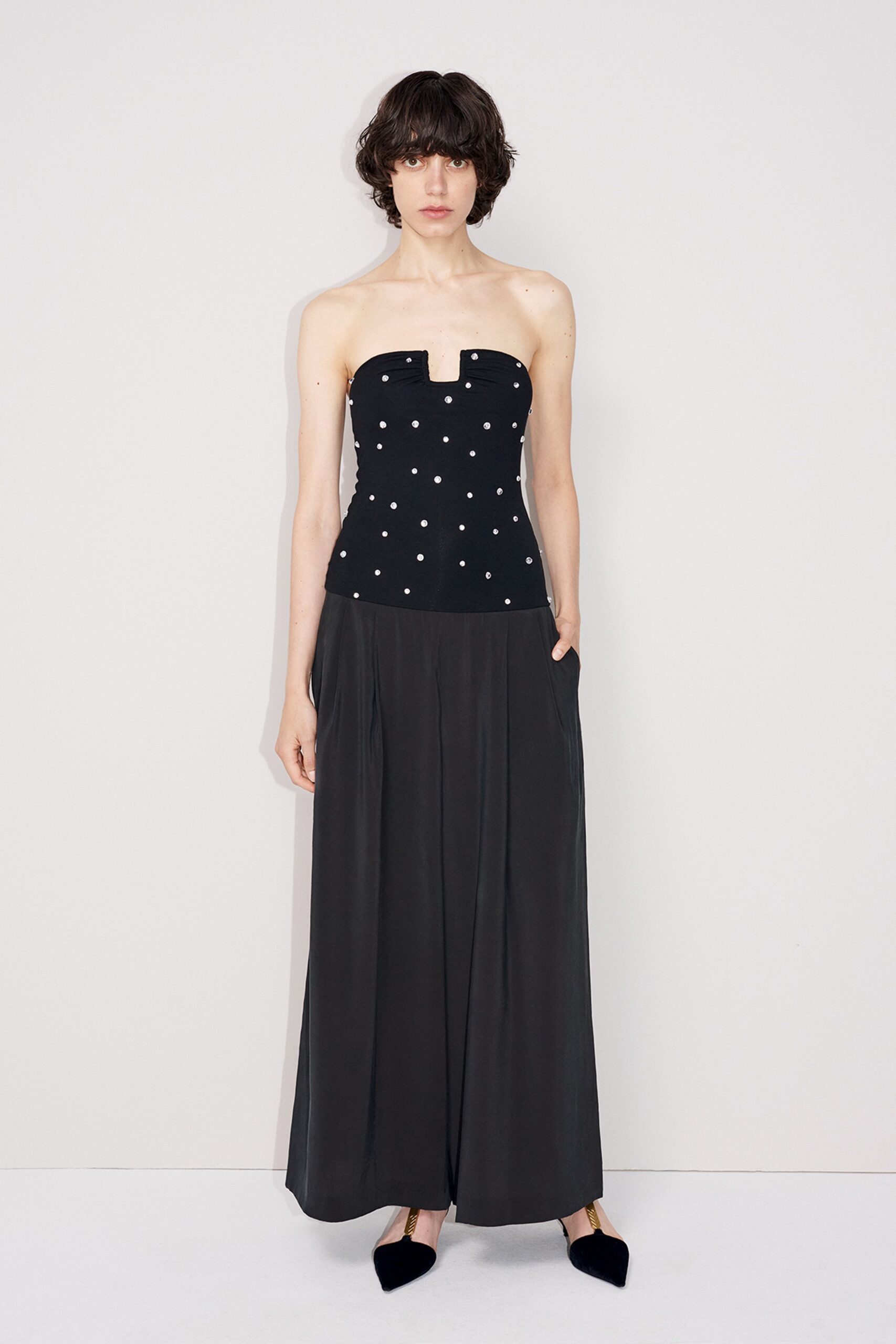 black strapless top with pleated pants