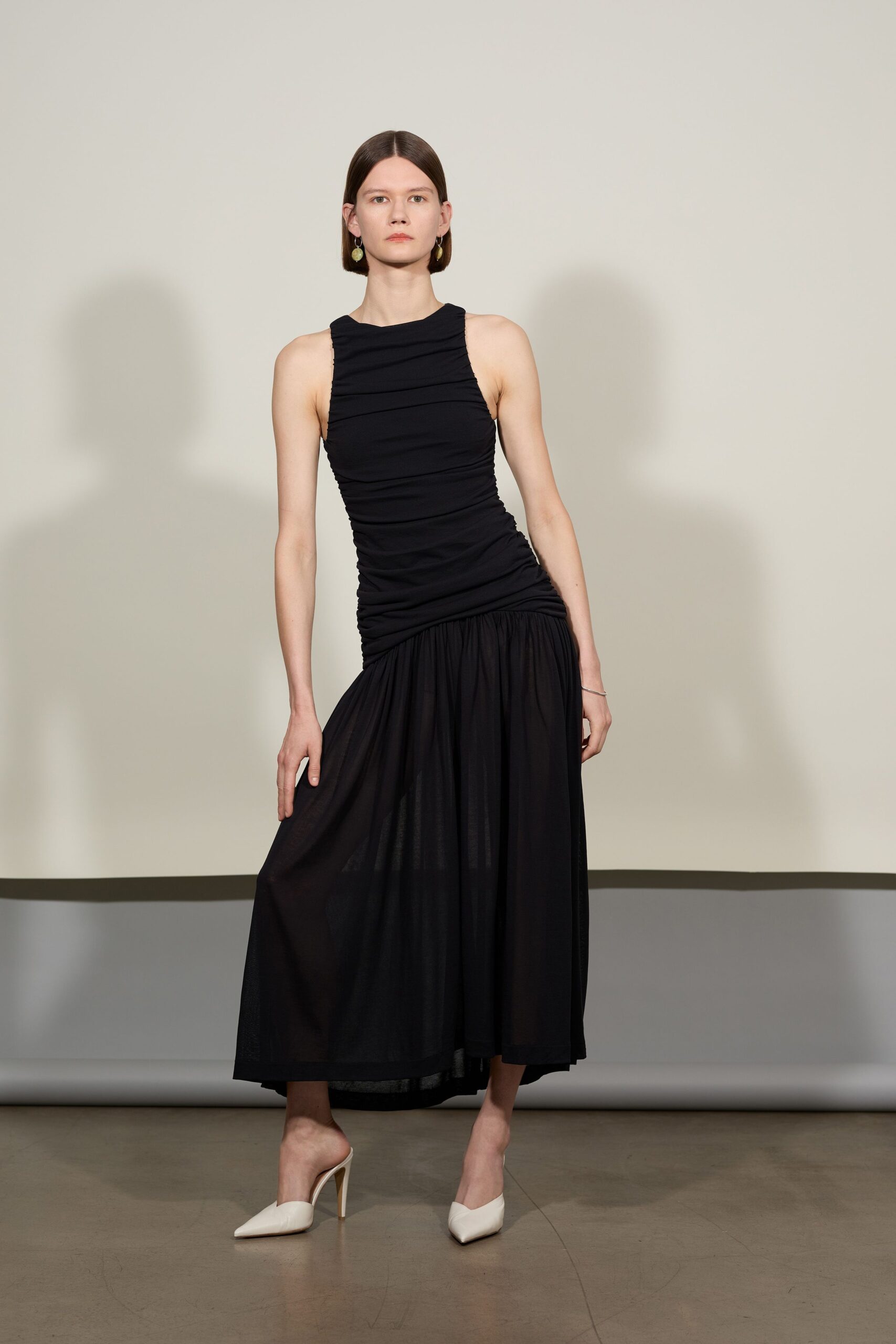 black fitted midi dress with white shoes
