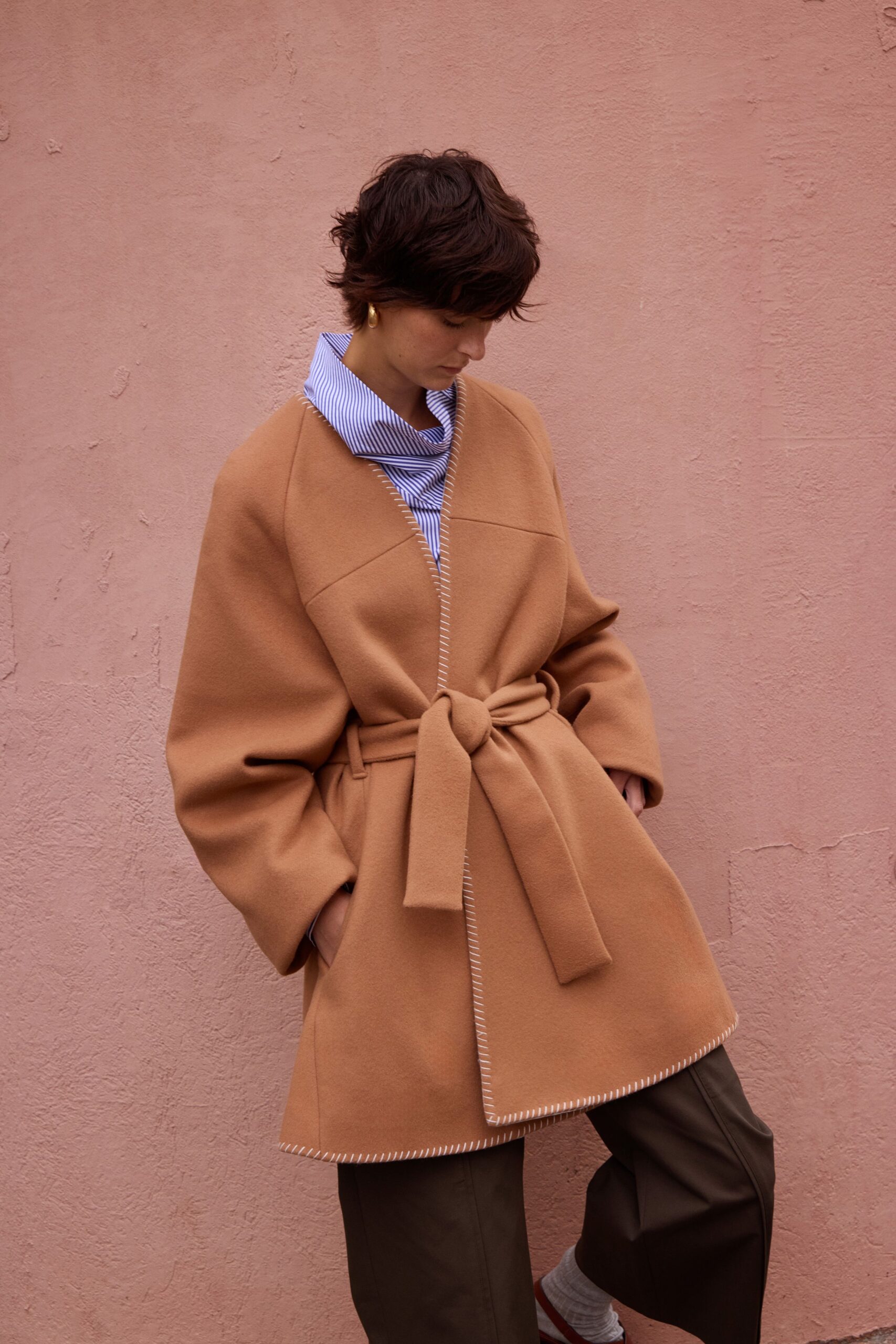 brown belted coat with striped shirt