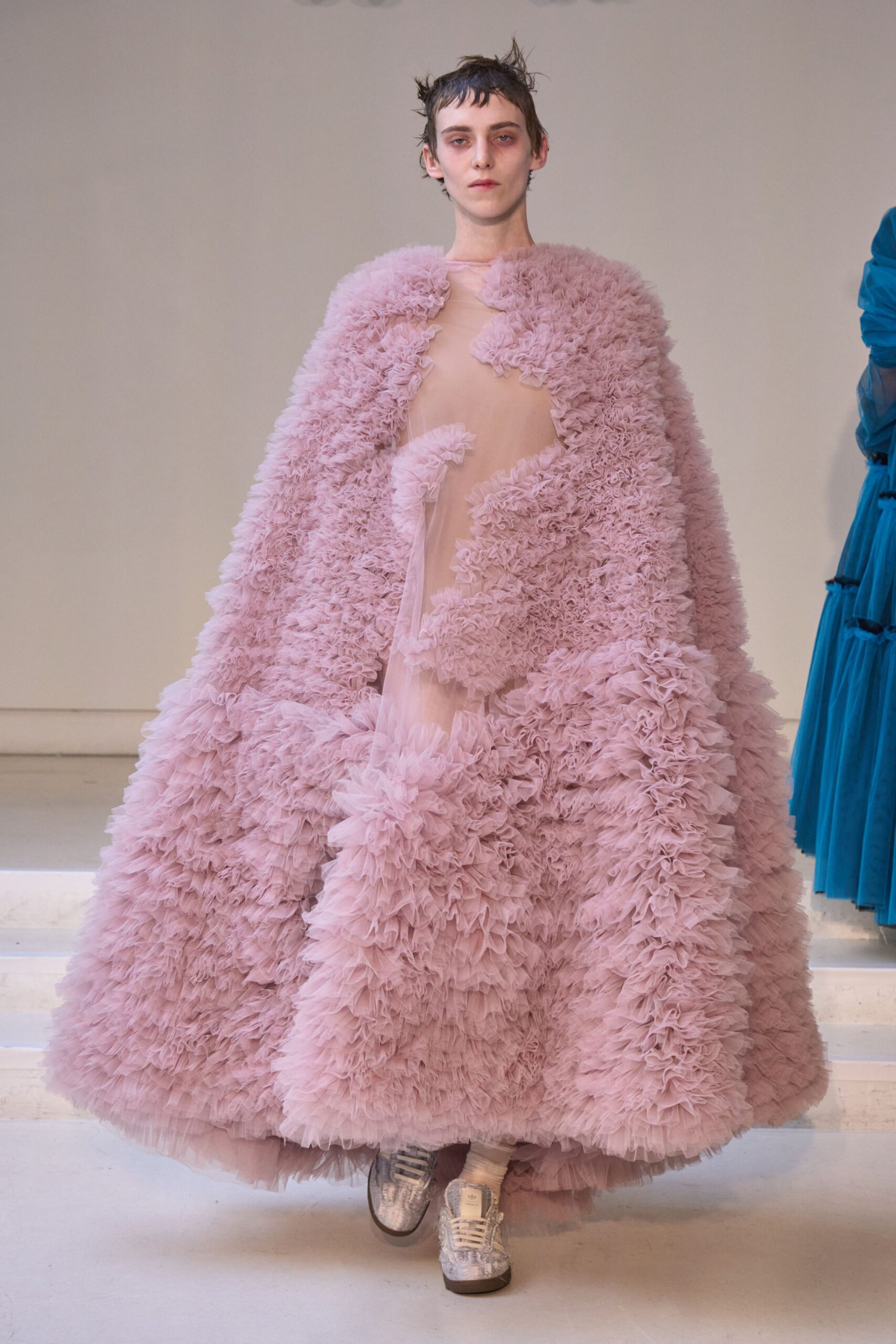 pink fringed cape with beige dress