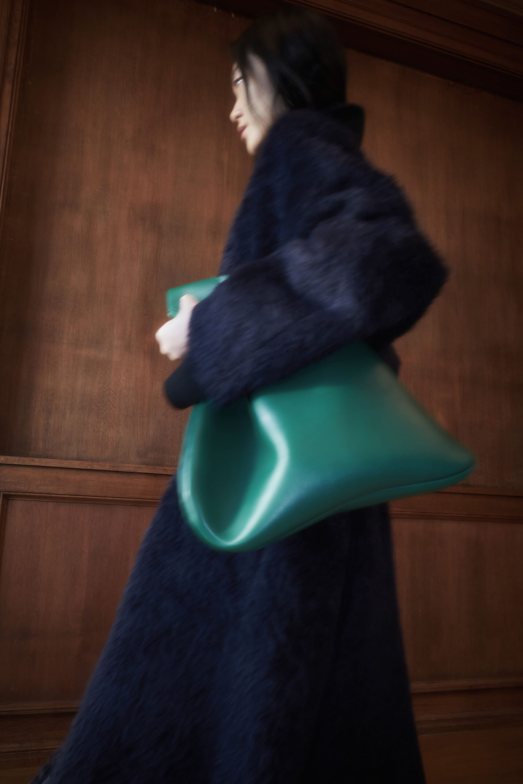 black oversized faux-fur coat with green bag