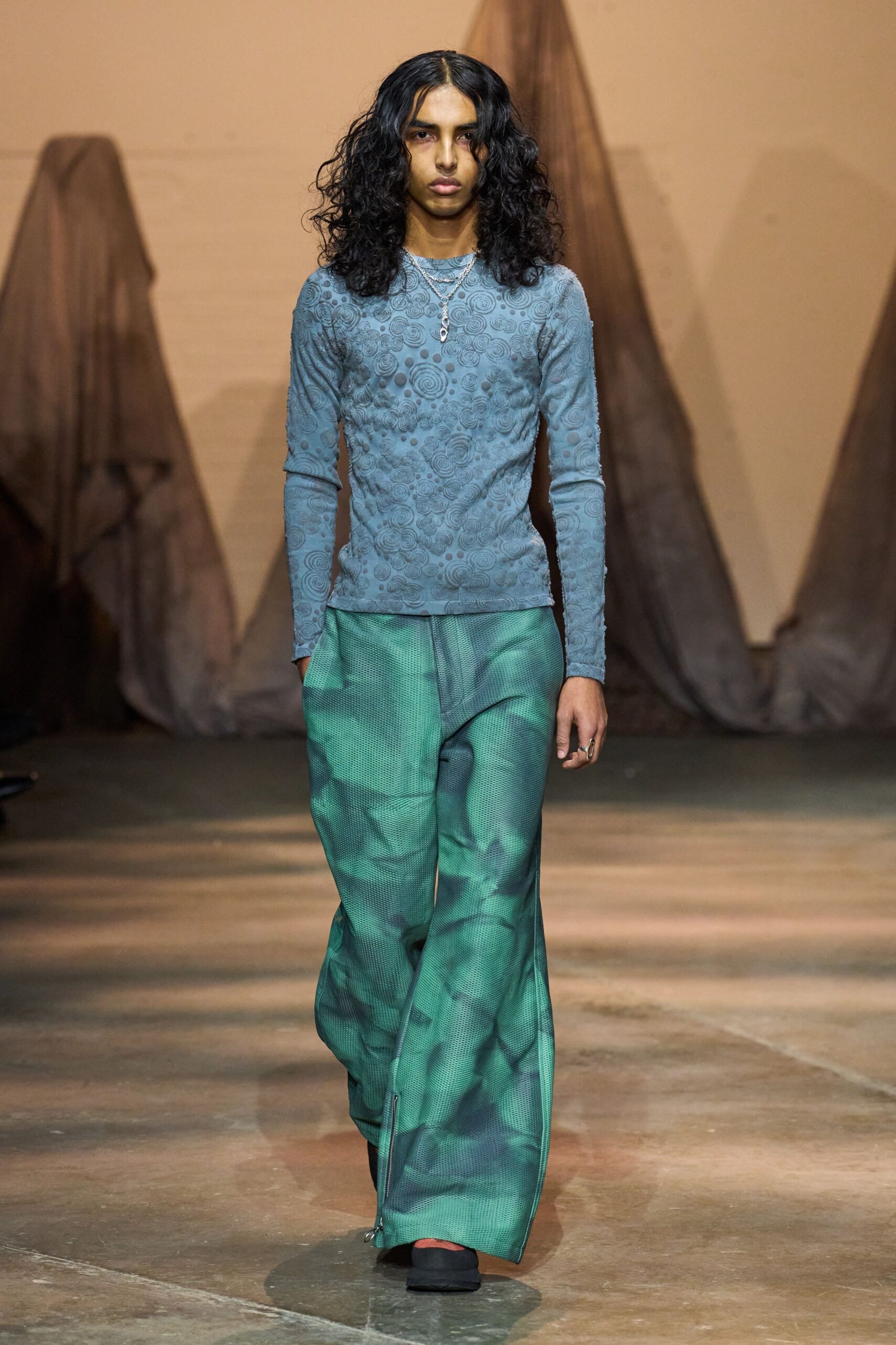 blue embroidered top with green pants