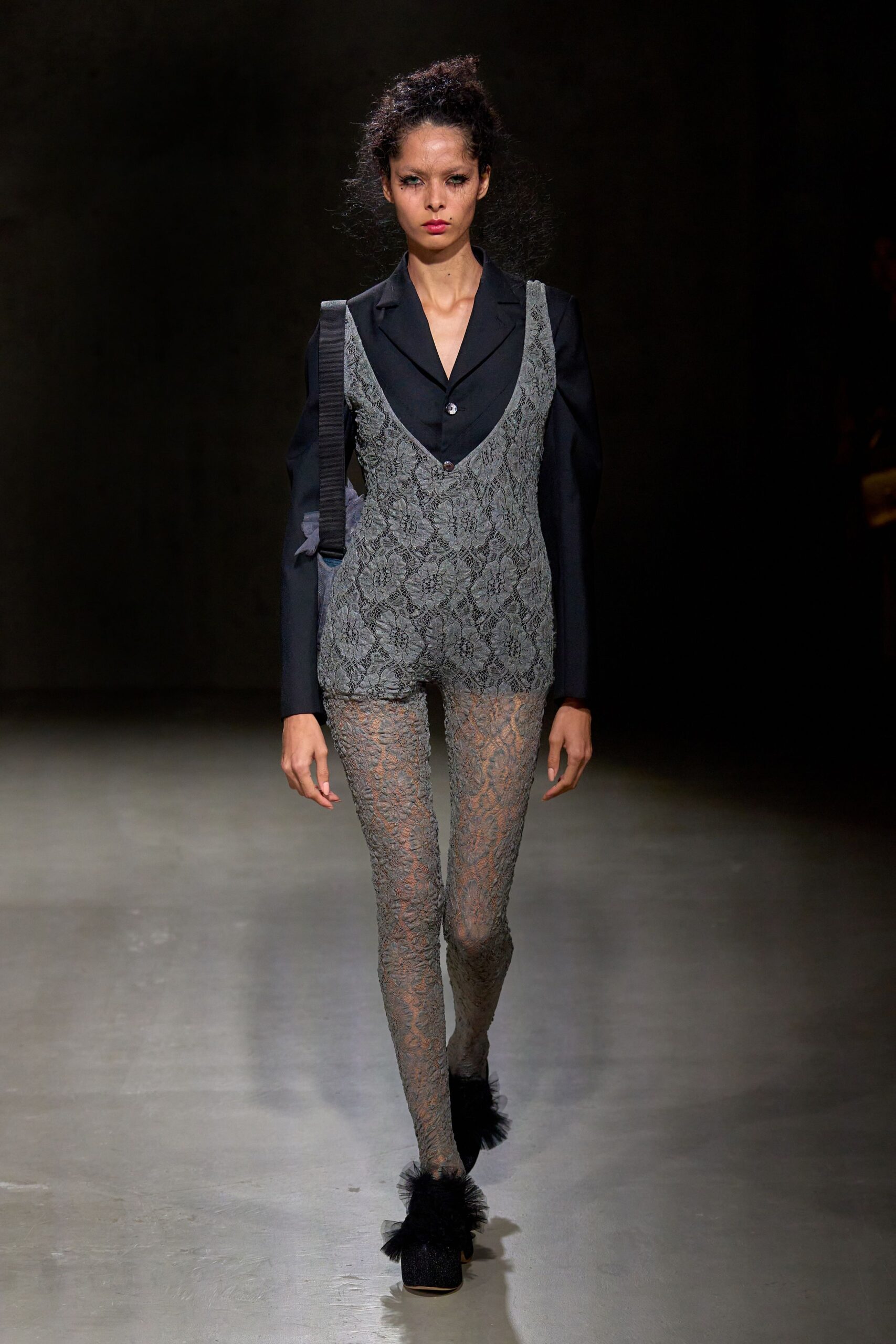 black lace layered top with gray pants