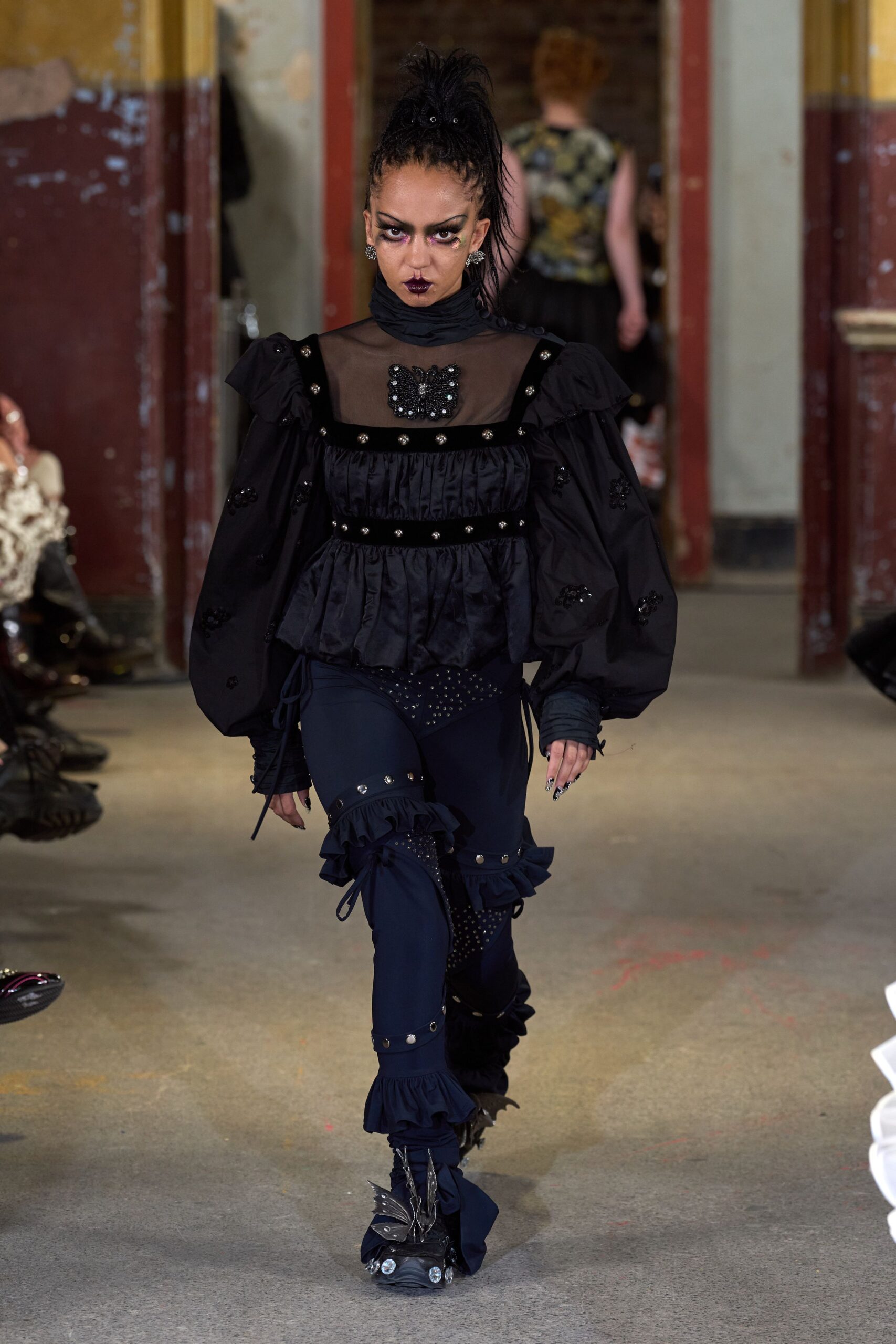 black fitted top and pants with boots