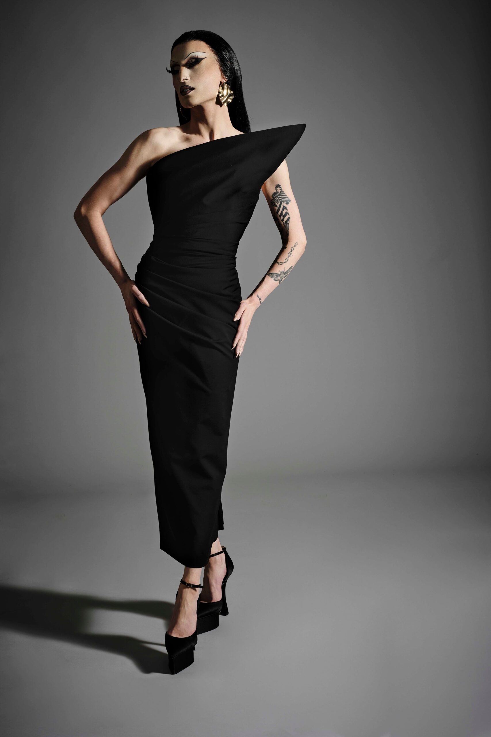 black fitted off-shoulder gown with heels