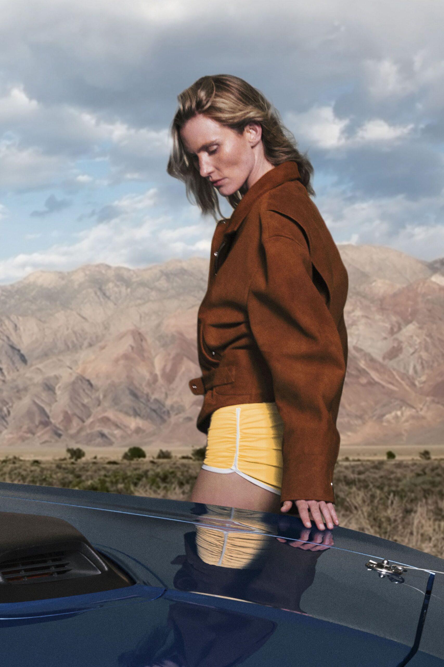 brown leather relaxed jacket and yellow shorts