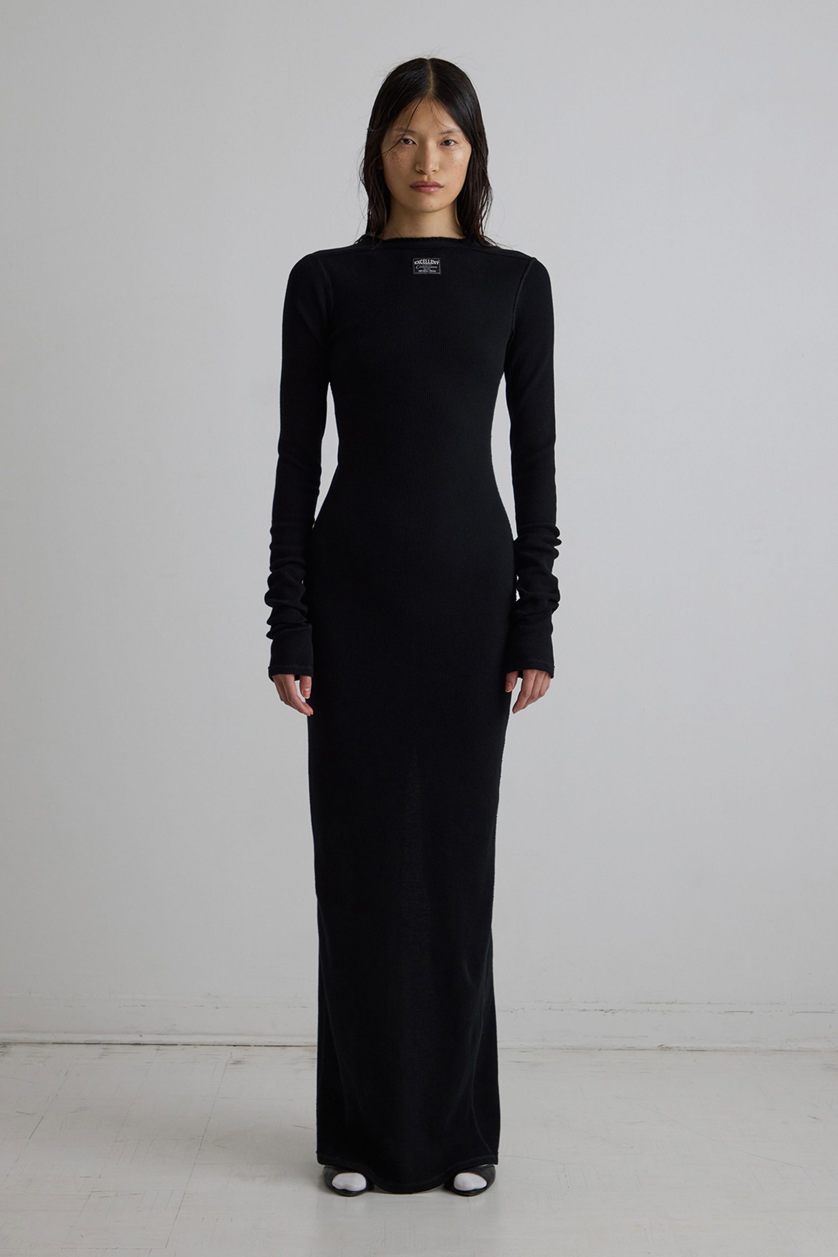 black fitted long-sleeve gown with white shoes