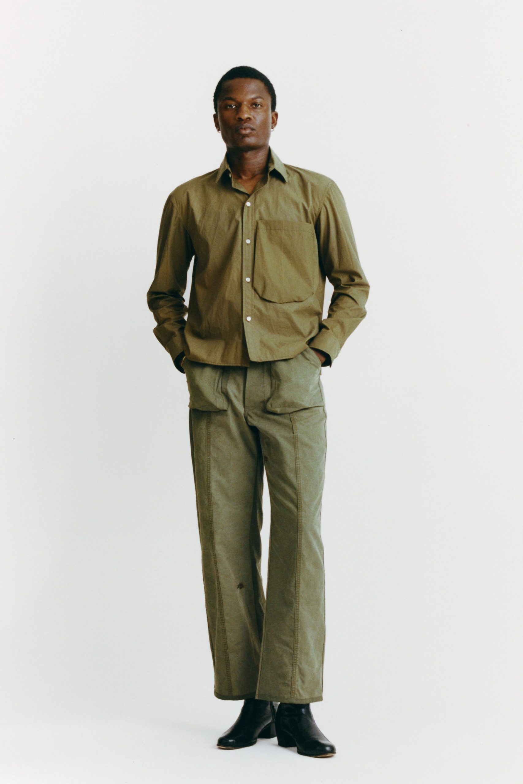 green cotton shirt and pants with black boots