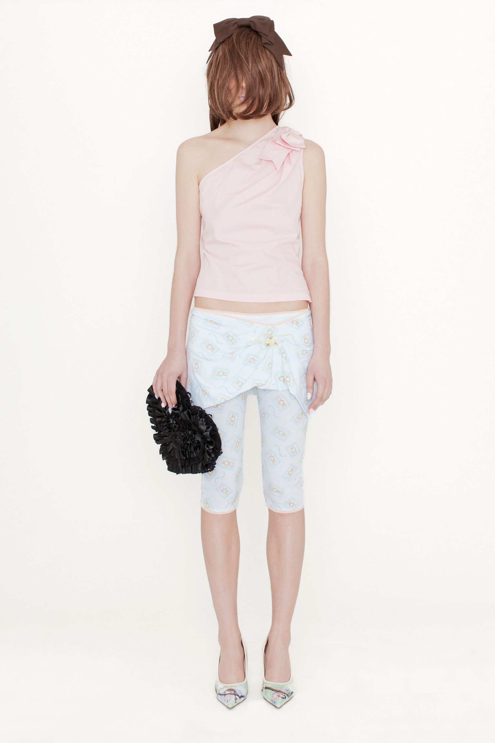 pink ruffled top with printed pants