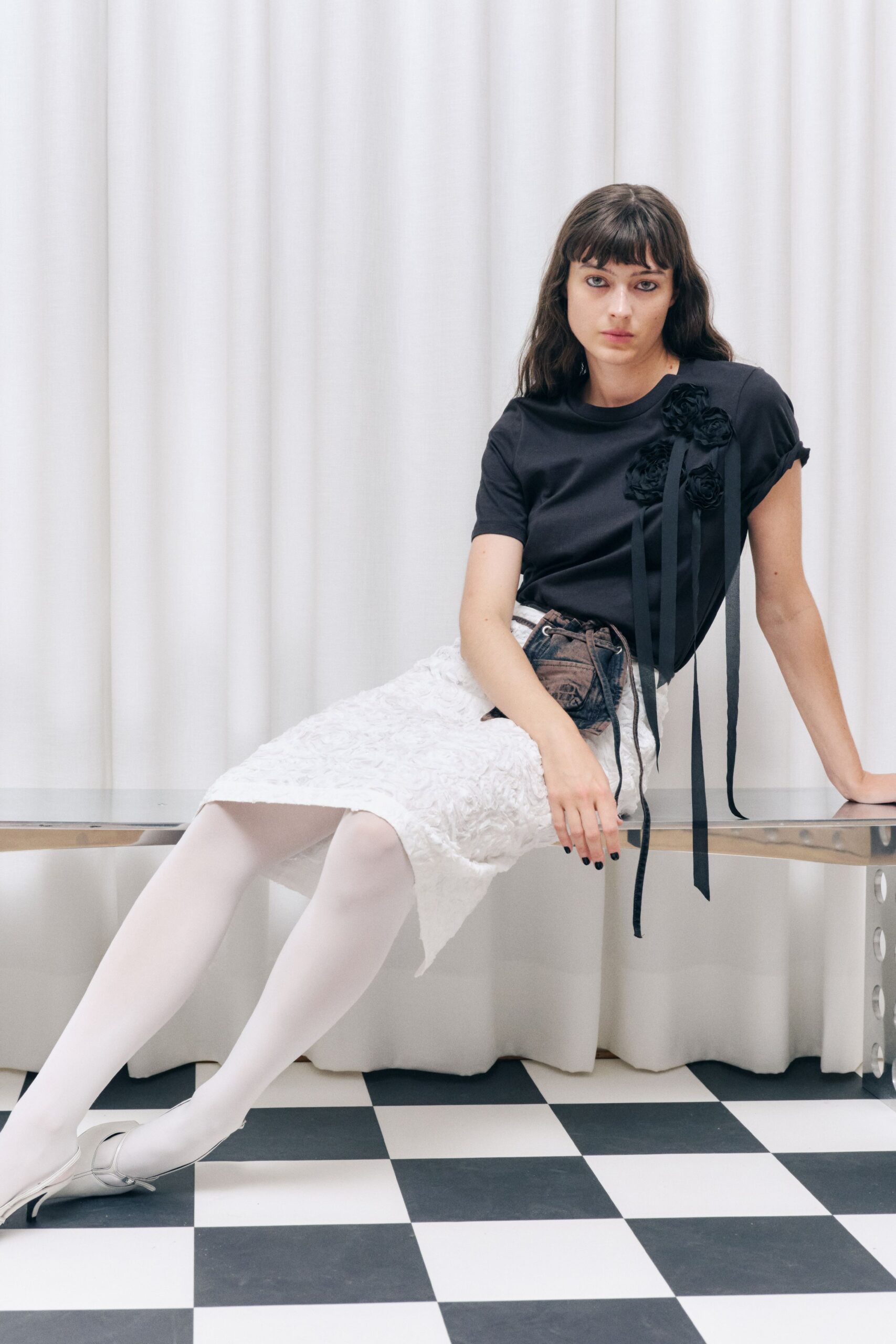 black fitted top with white lace skirt