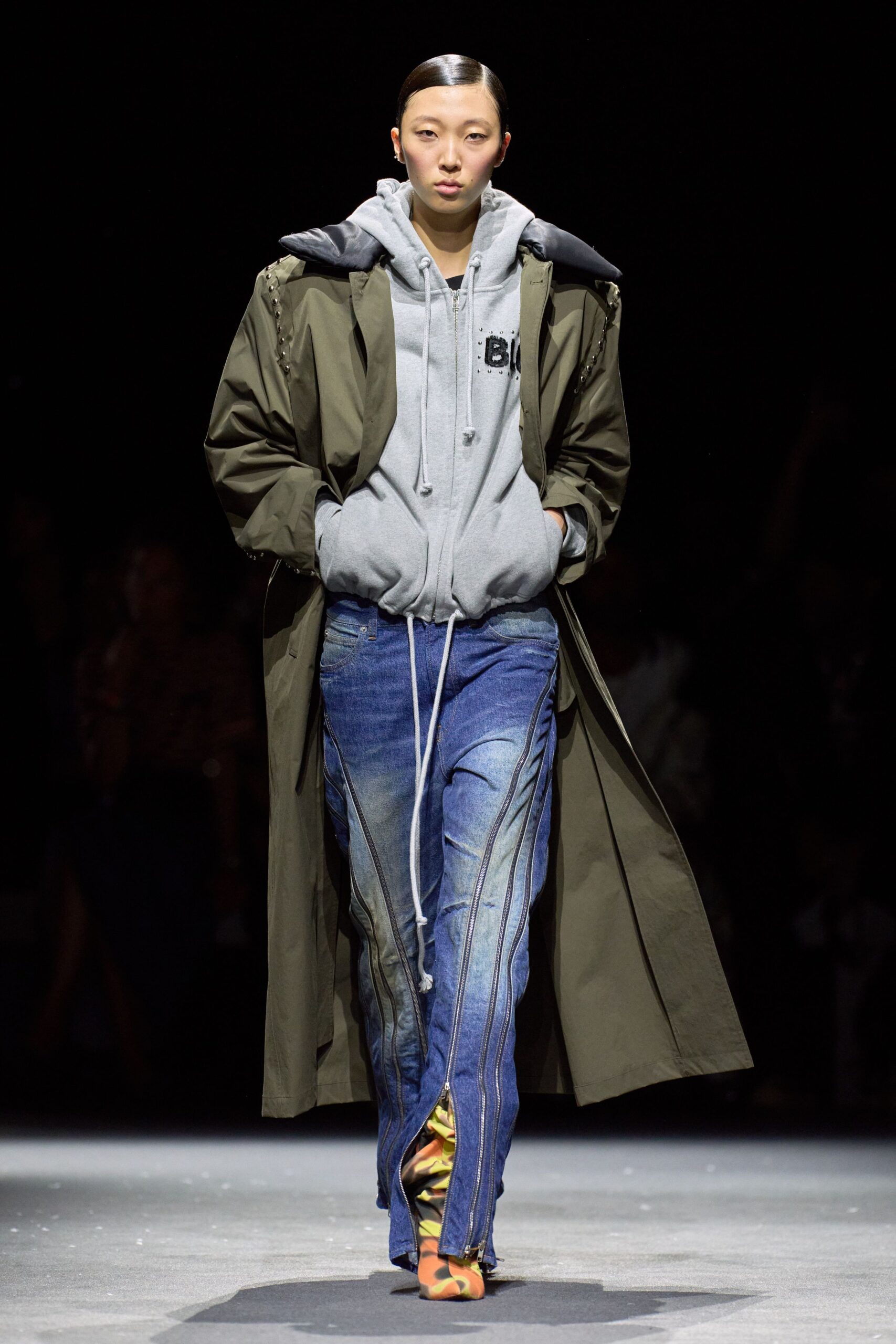 green coat gray hoodie blue pants