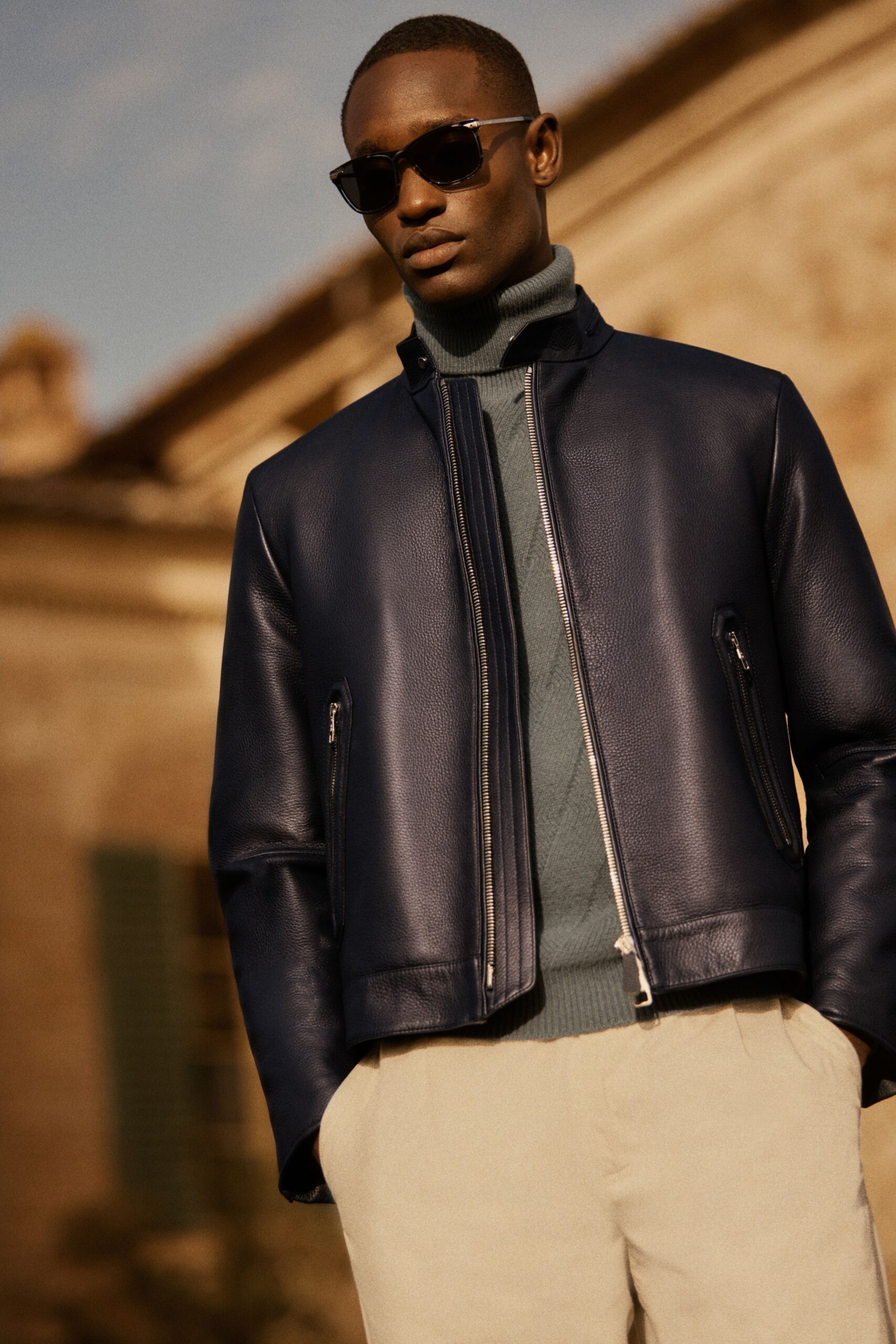 blue leather jacket with gray turtleneck