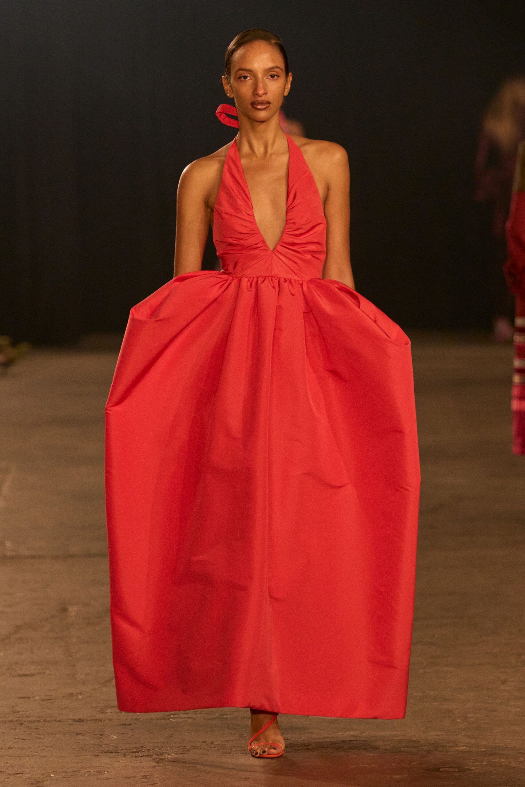 red sleeveless gown with pleats
