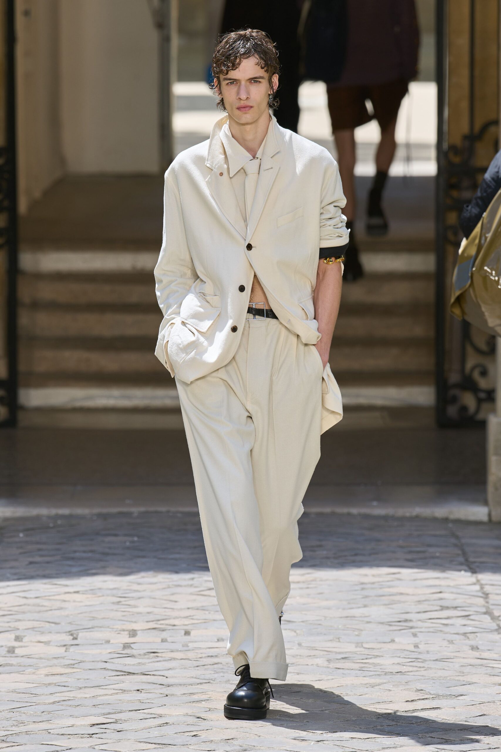 beige relaxed suit with black shoes