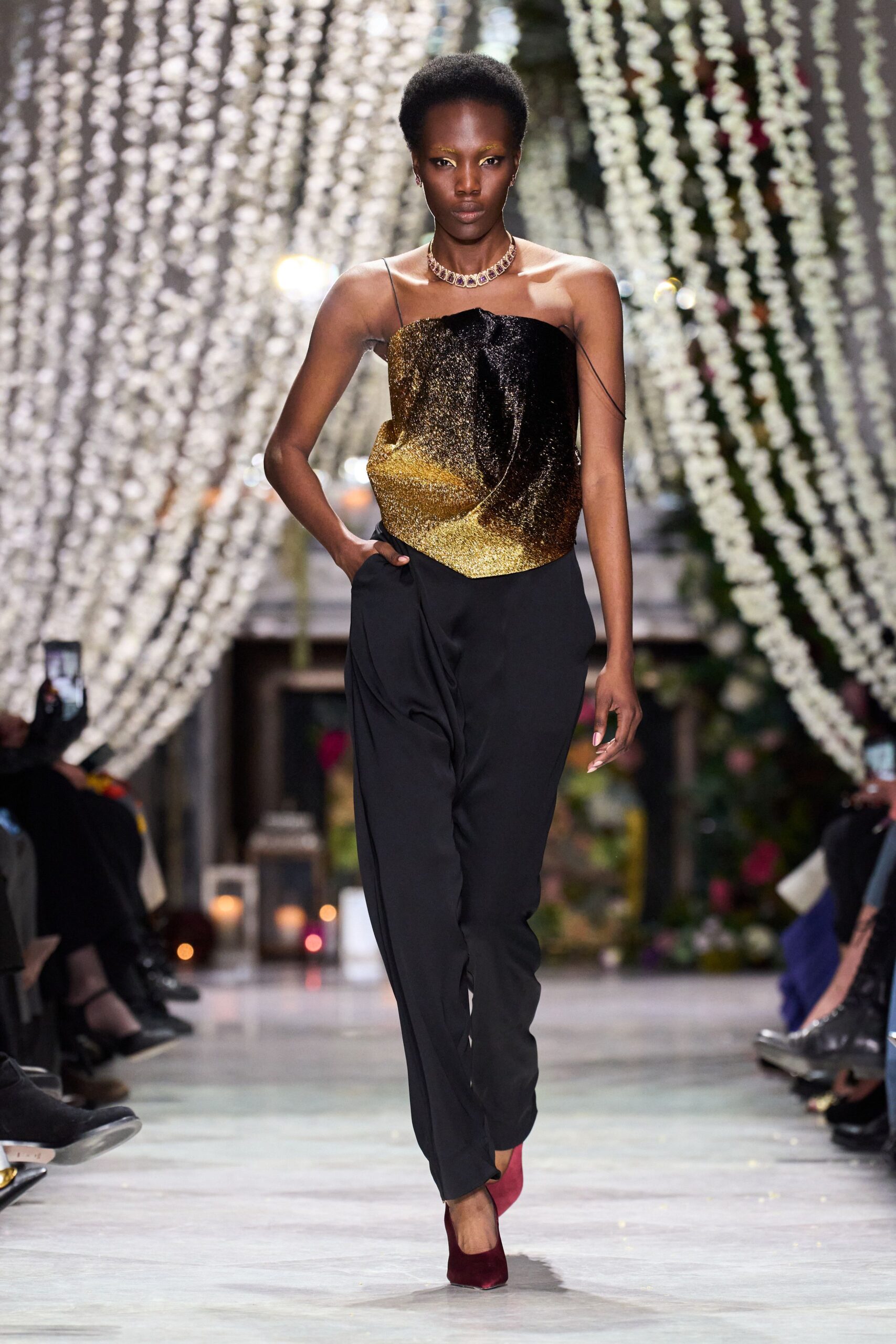 black and gold fitted top with tailored pants