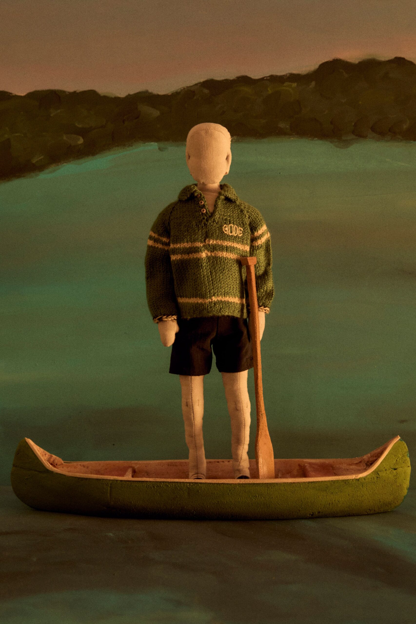 green striped sweater with black shorts