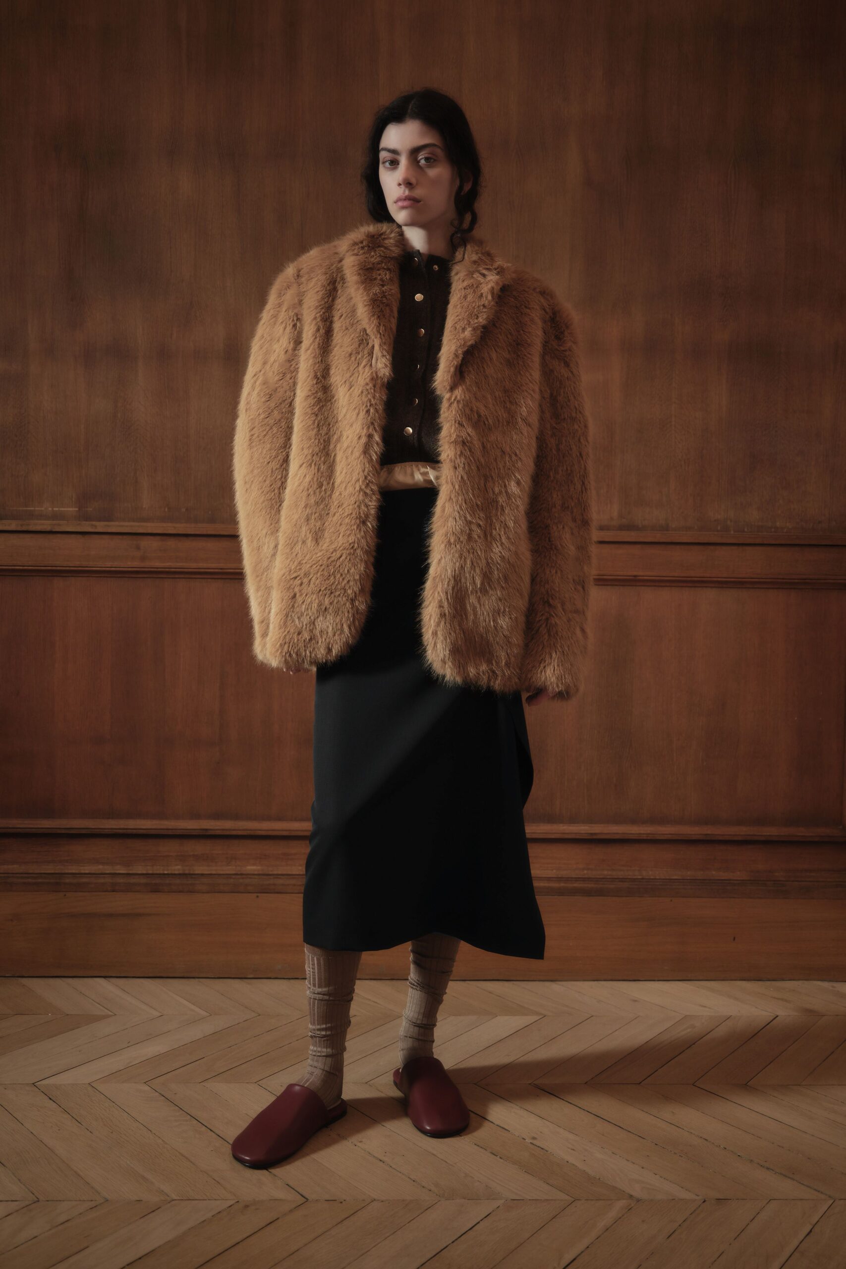 brown faux-fur coat and black skirt