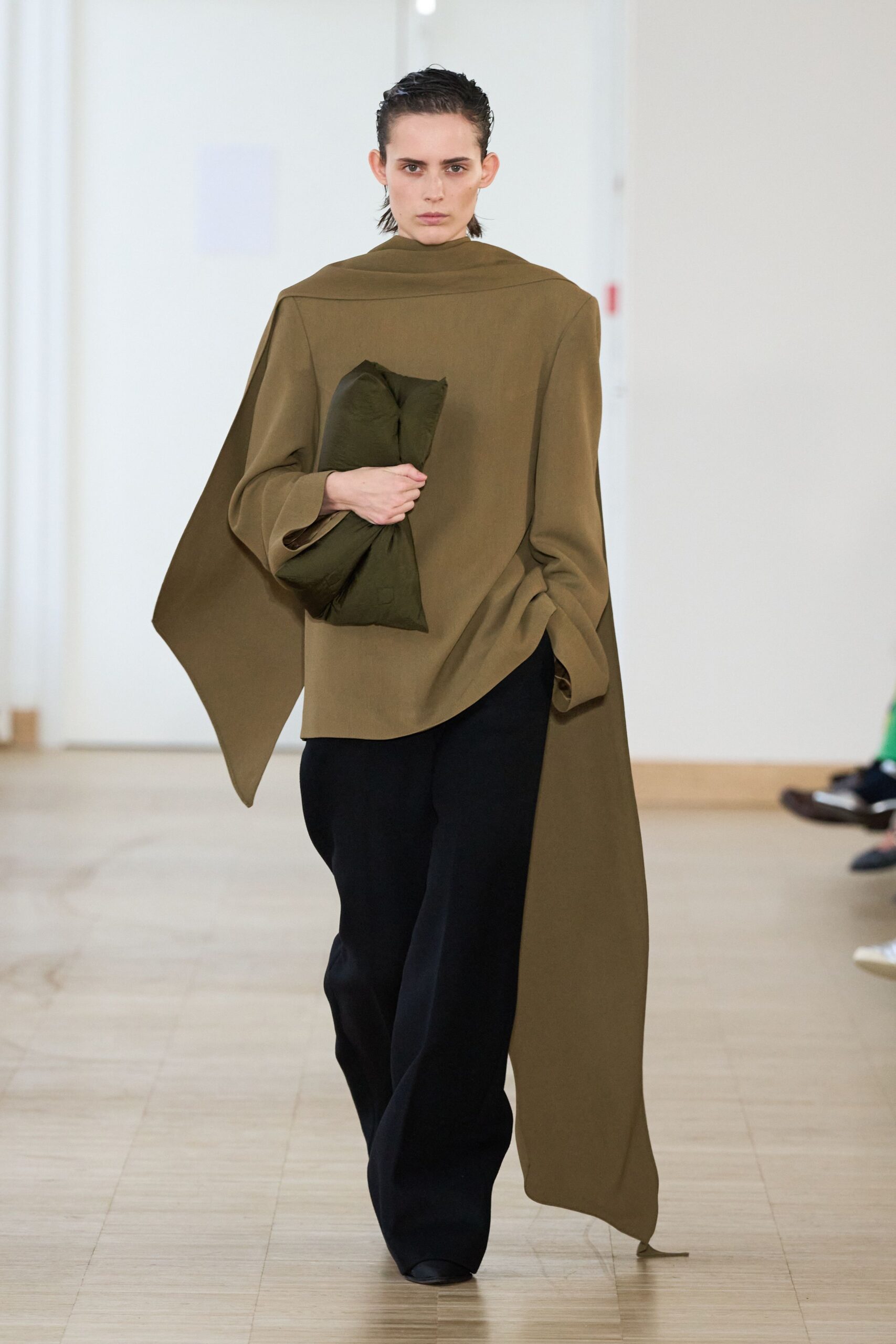 green relaxed top with black pants