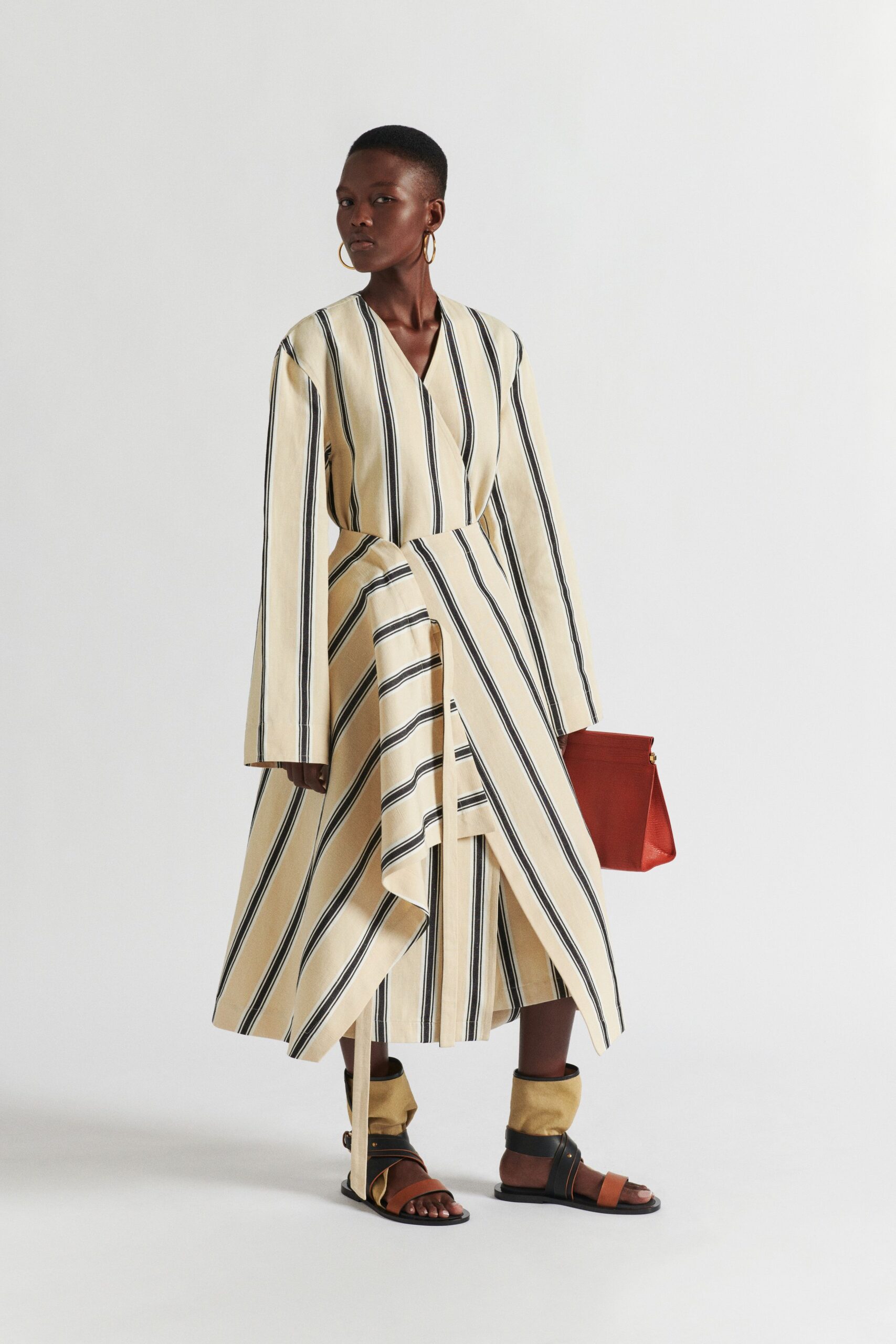 beige striped midi dress with red bag