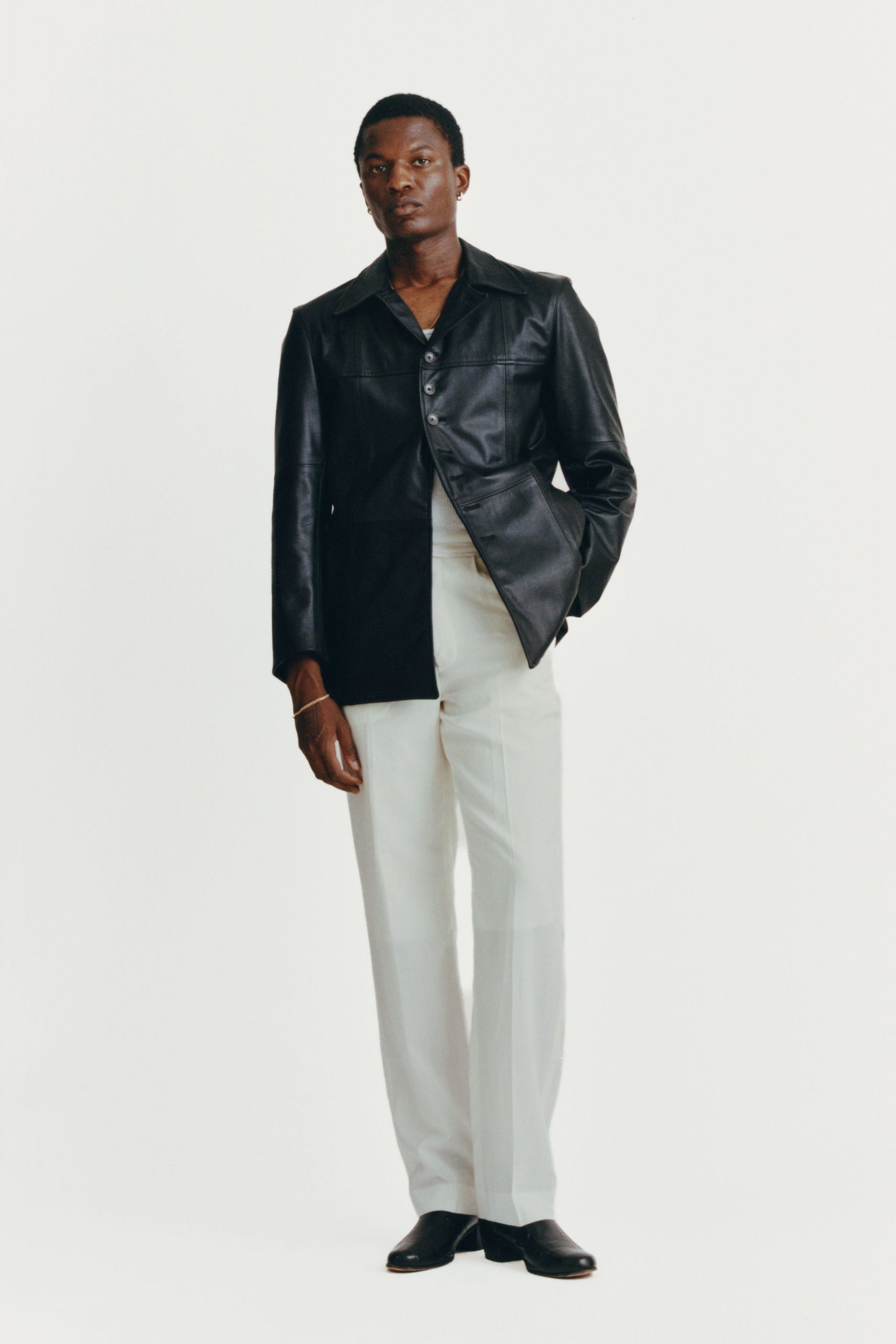 black leather jacket with white pants