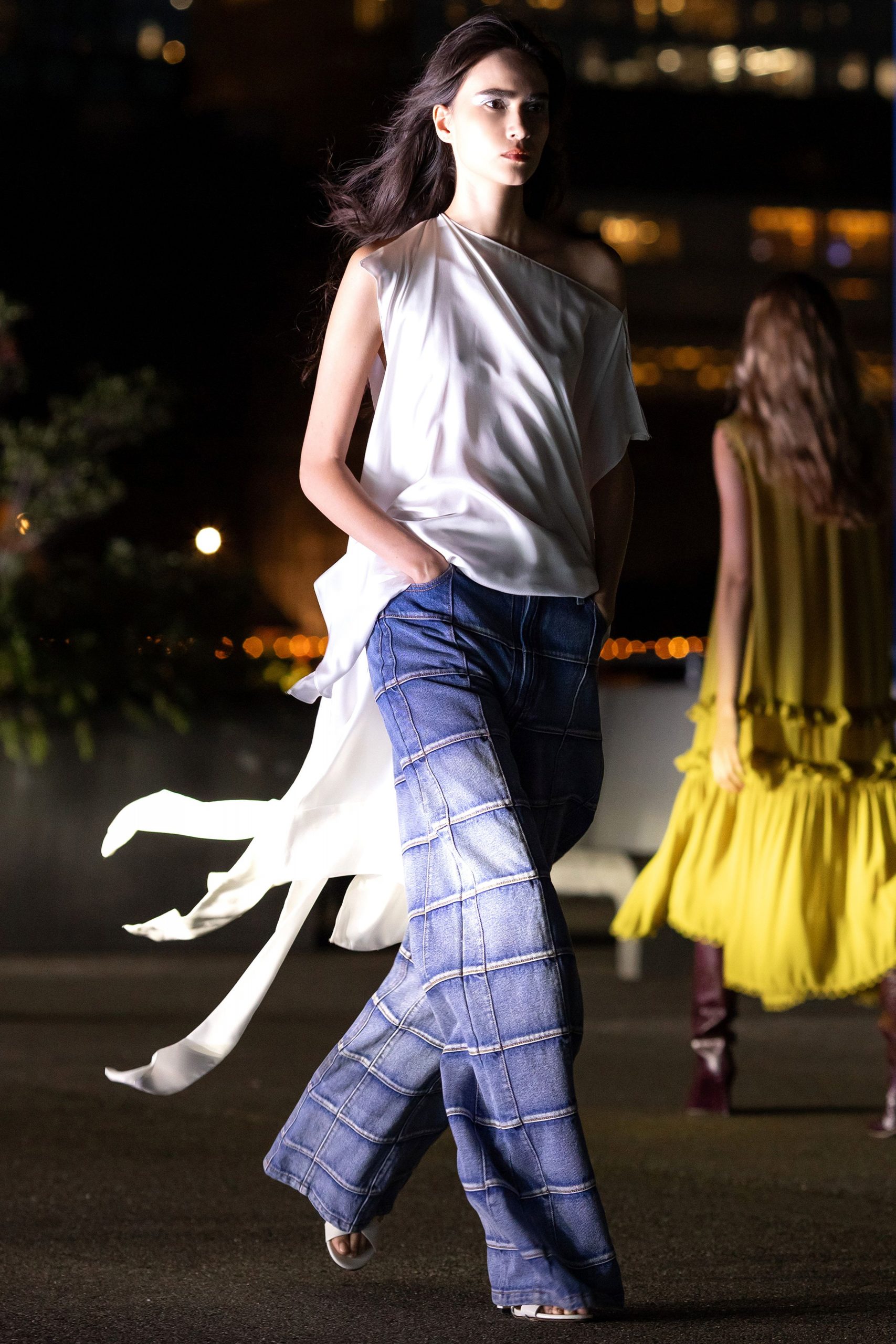 white silk off-shoulder top and blue checked pants