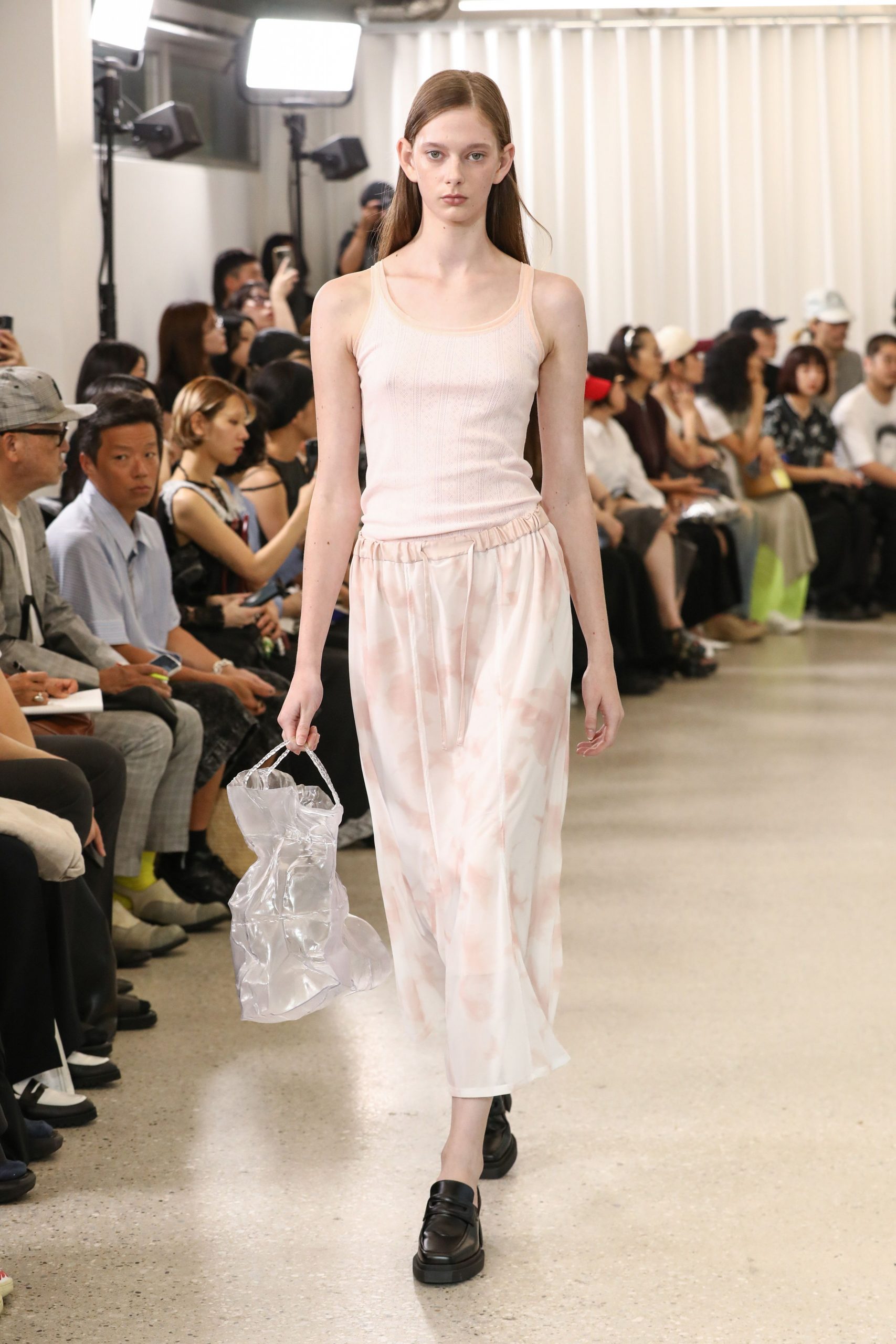 pink tank-top and white pleated skirt