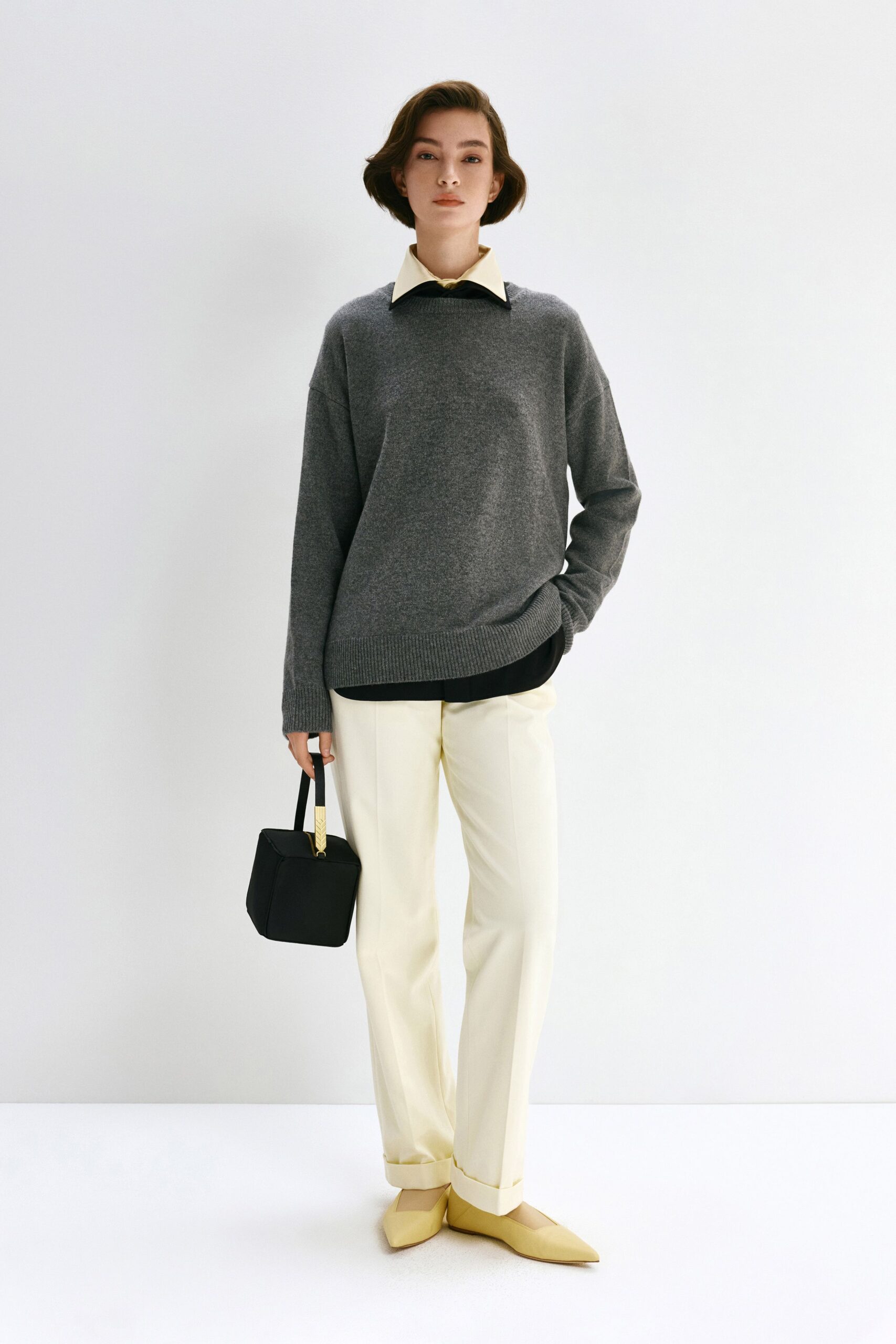 gray wool relaxed sweater with white tailored pants