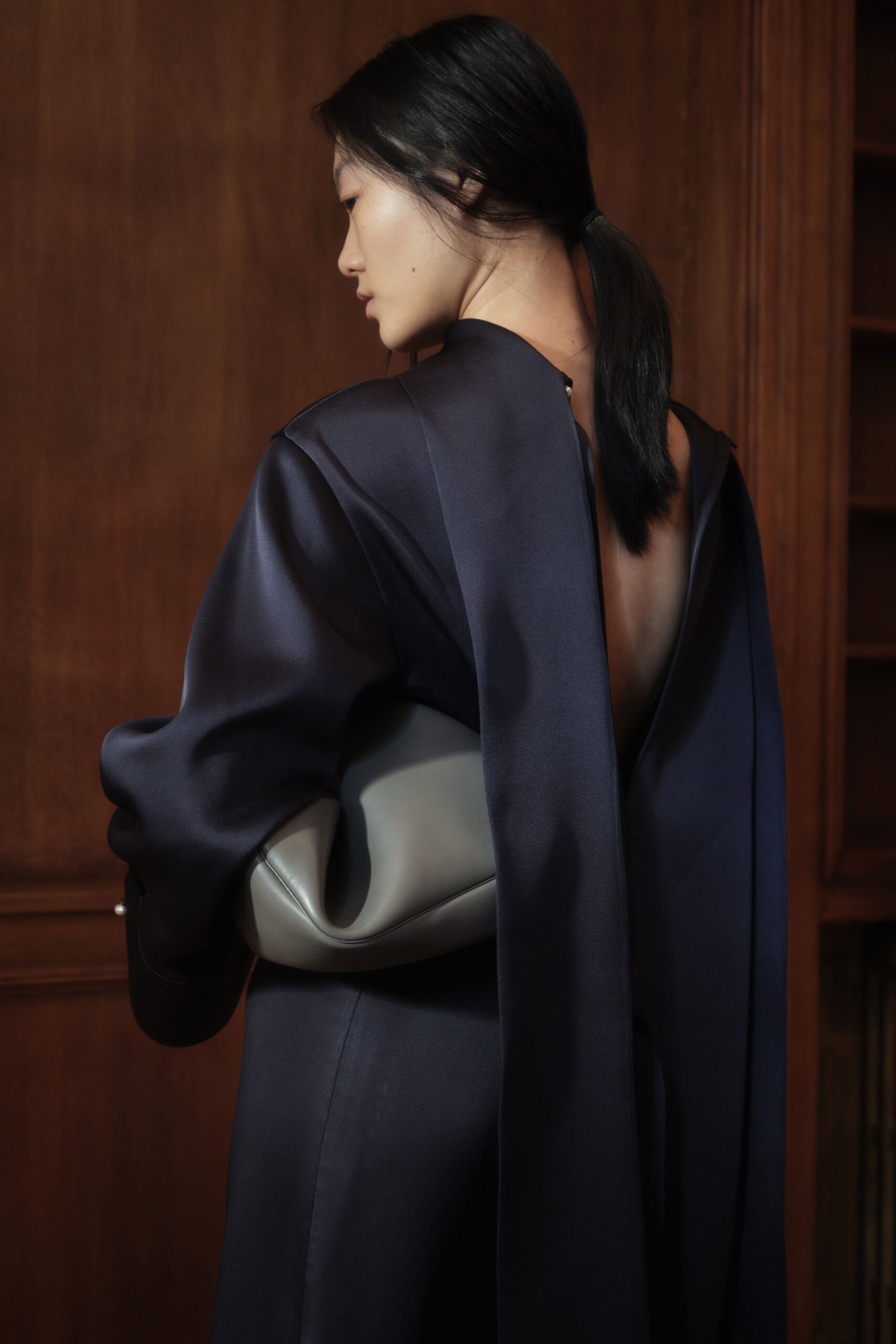 navy silk backless dress with gray bag