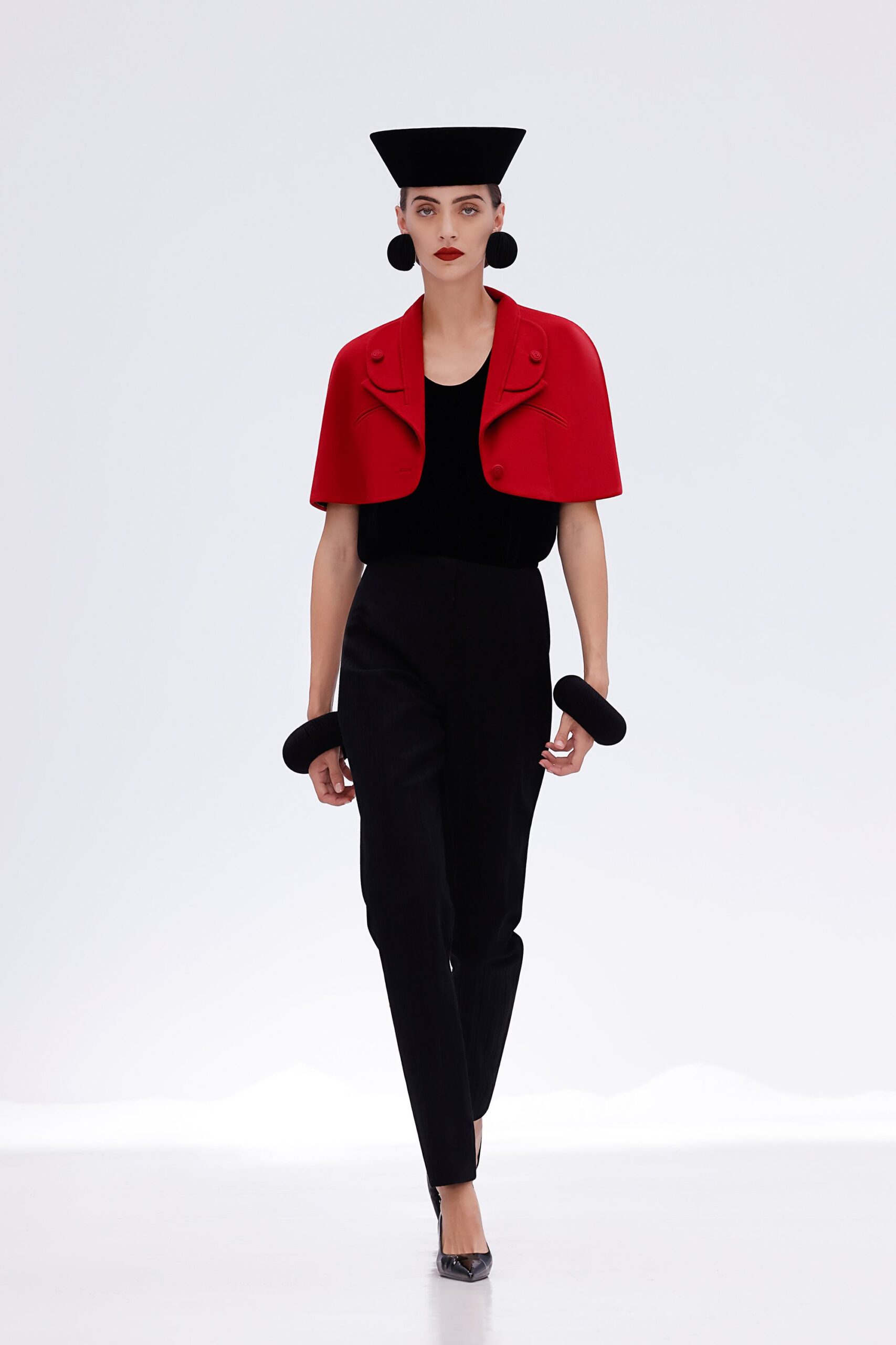 red cape black top and pants