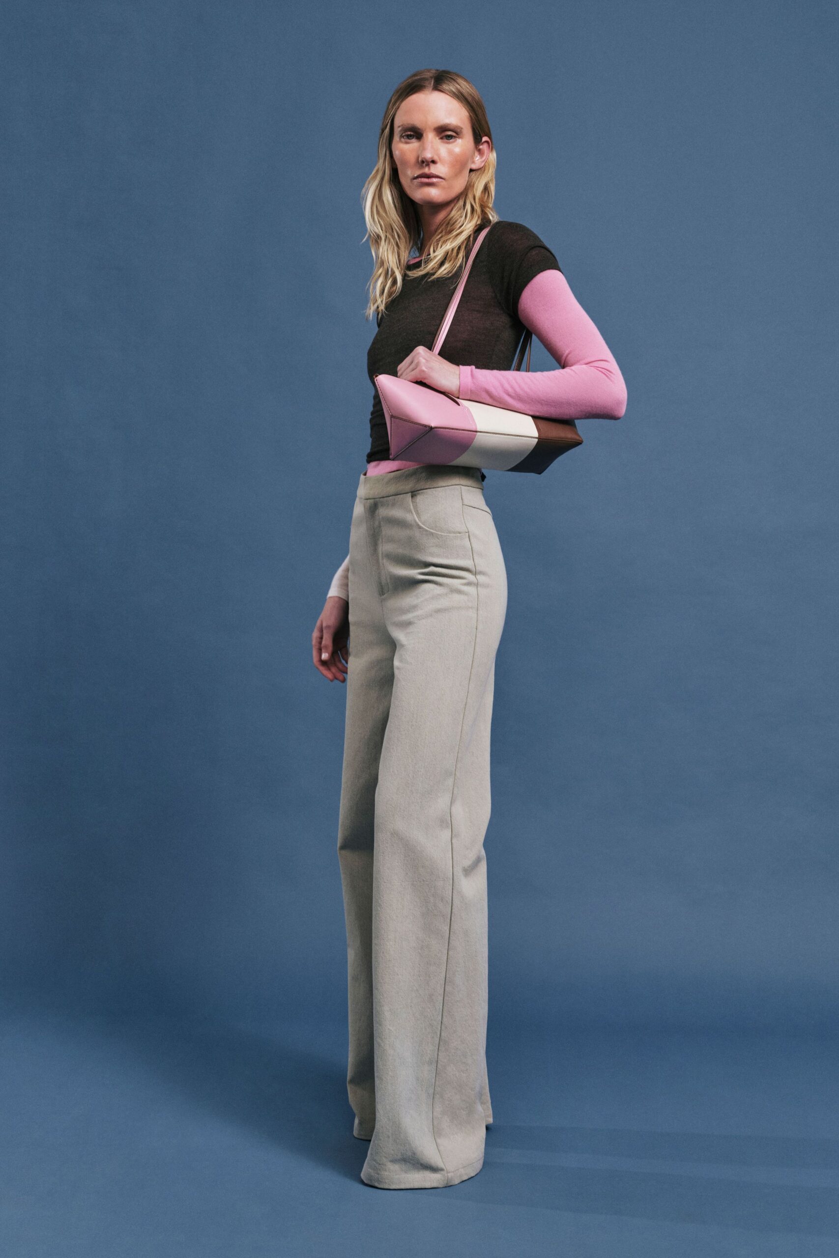 fitted black and pink top with tailored gray pants