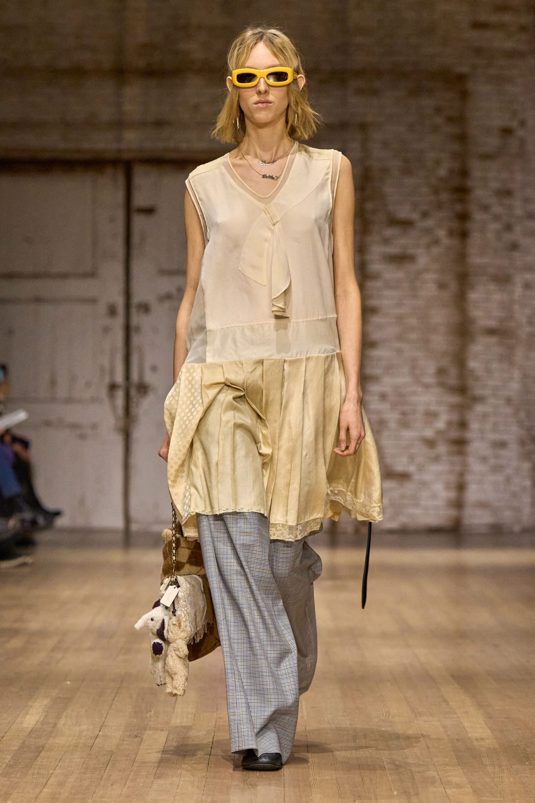beige silk sleeveless top with gray tailored pants