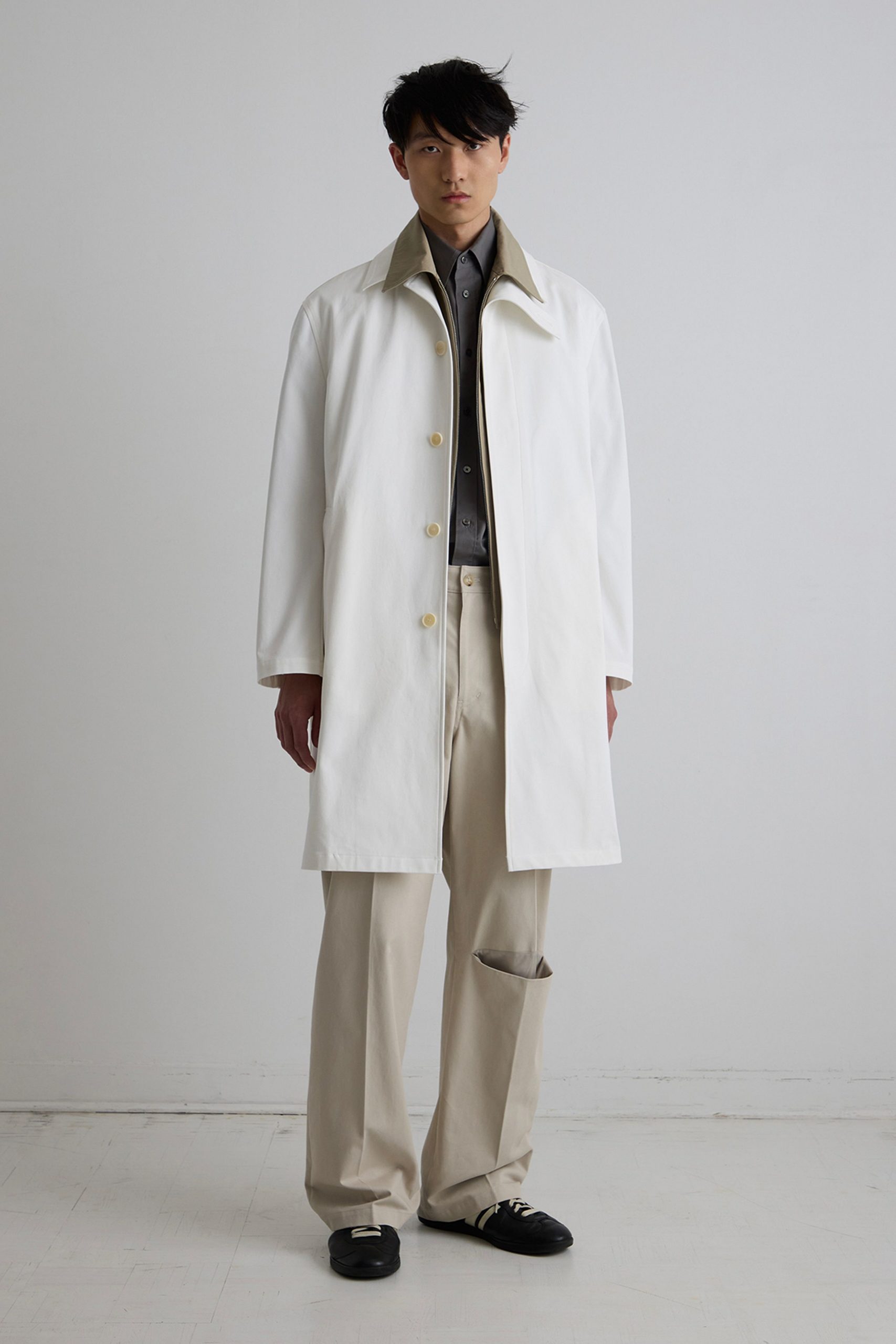 white coat gray shirt beige pants