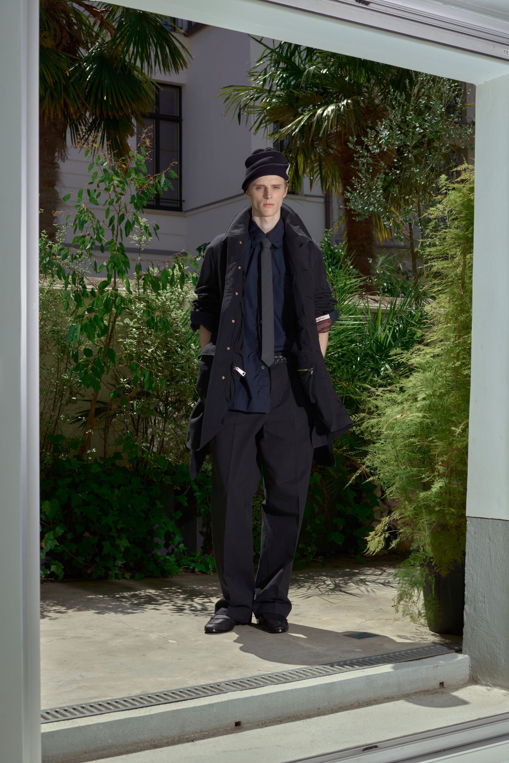 black wool long-sleeve collared oversized layered buttoned coat