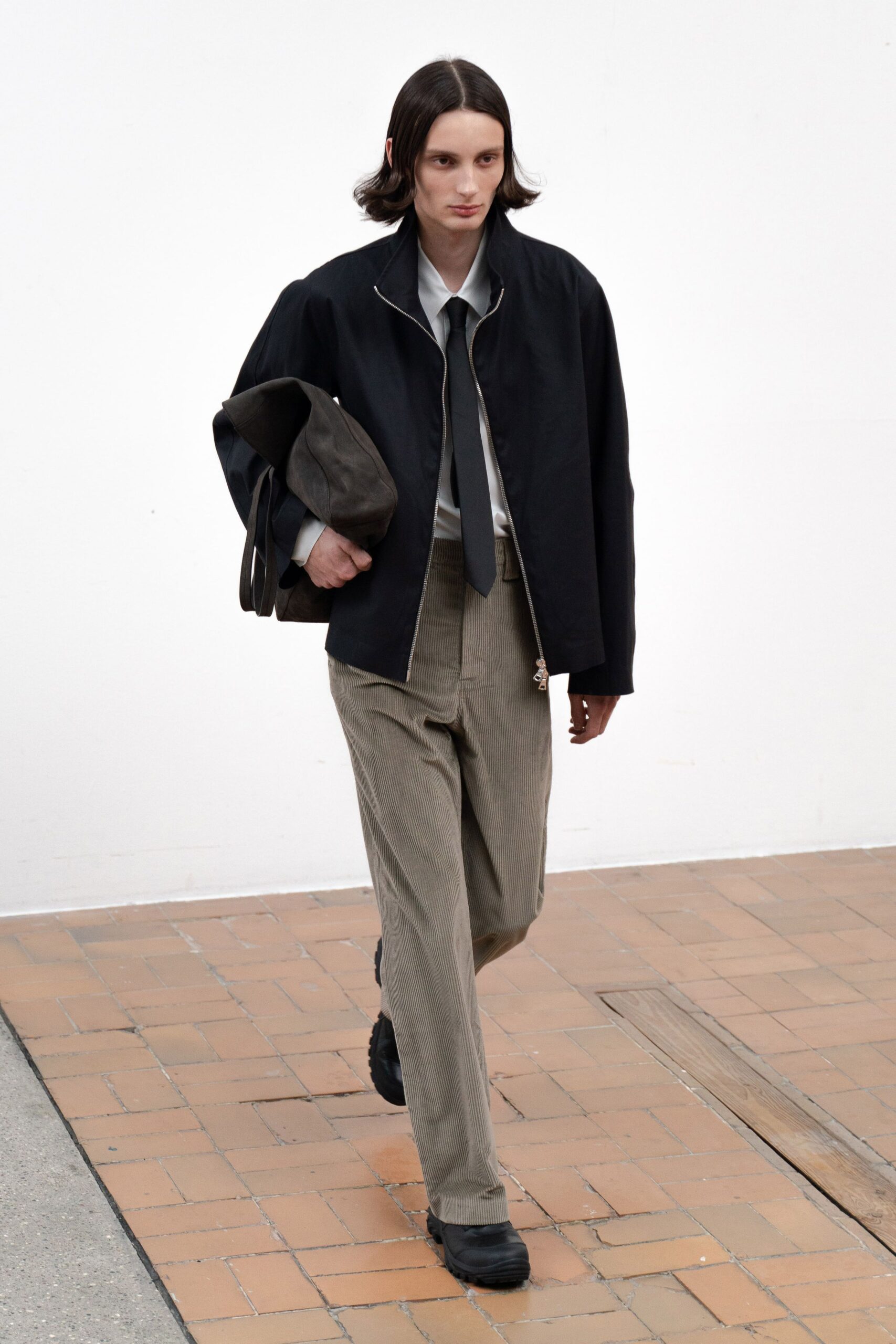 black relaxed jacket with beige pants