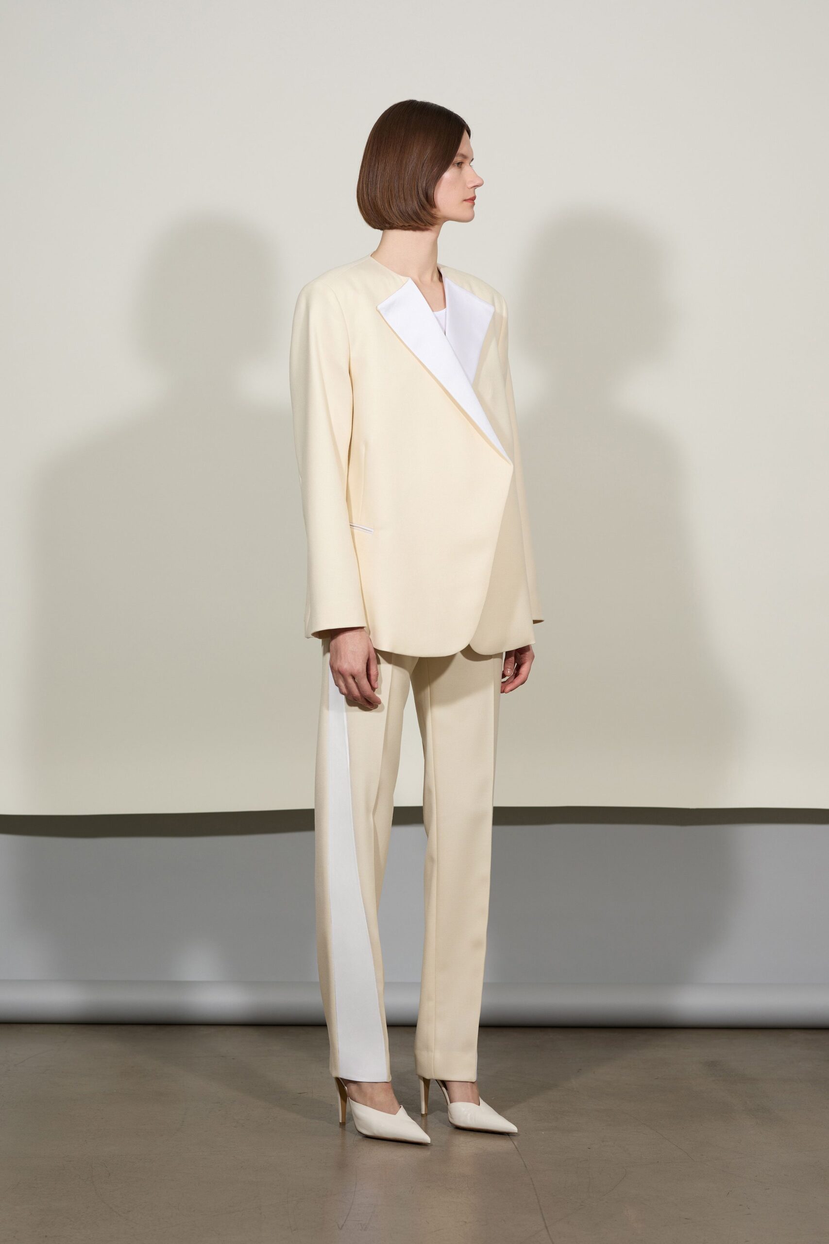 beige tailored suit with white shoes