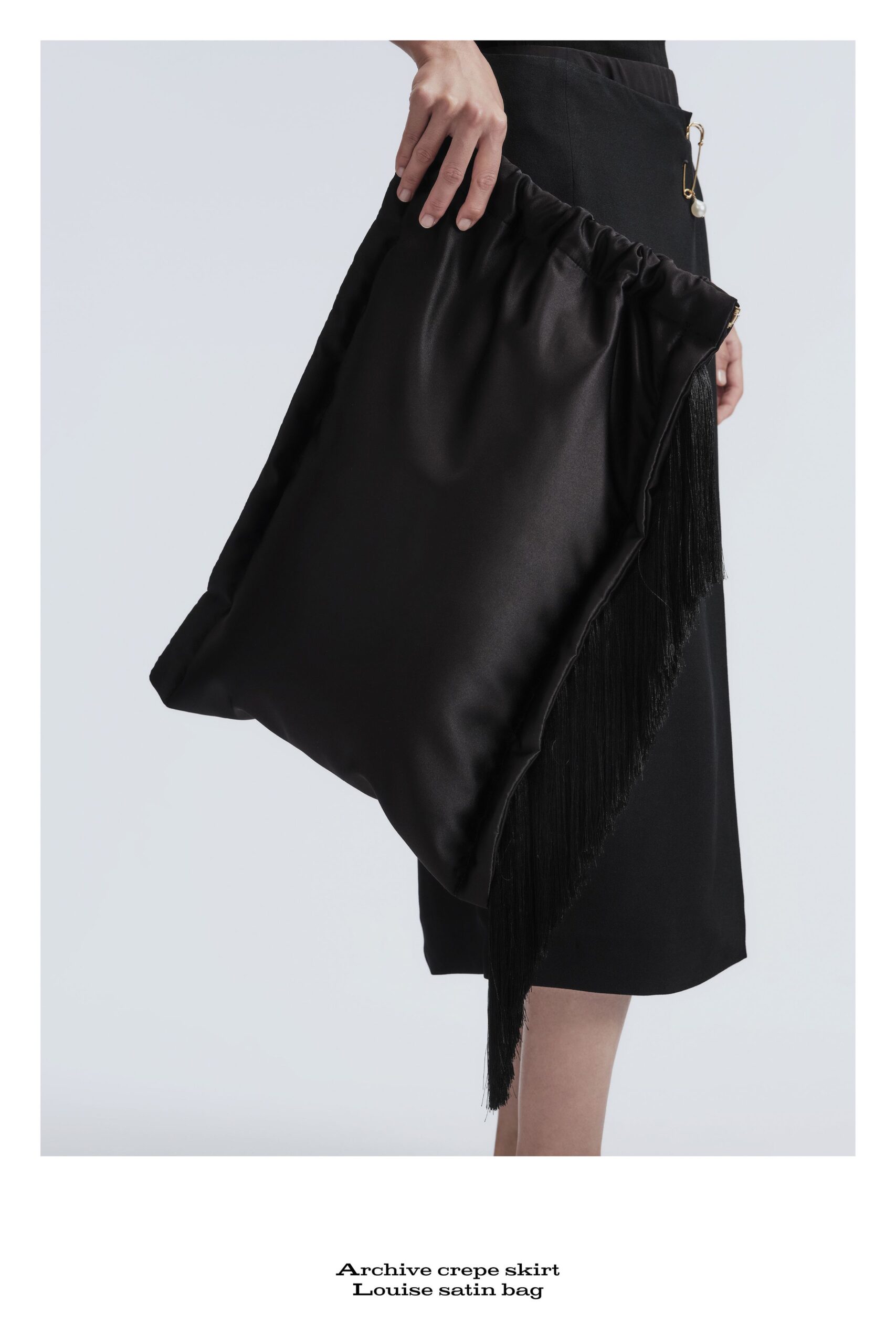 black crepe skirt and satin bag